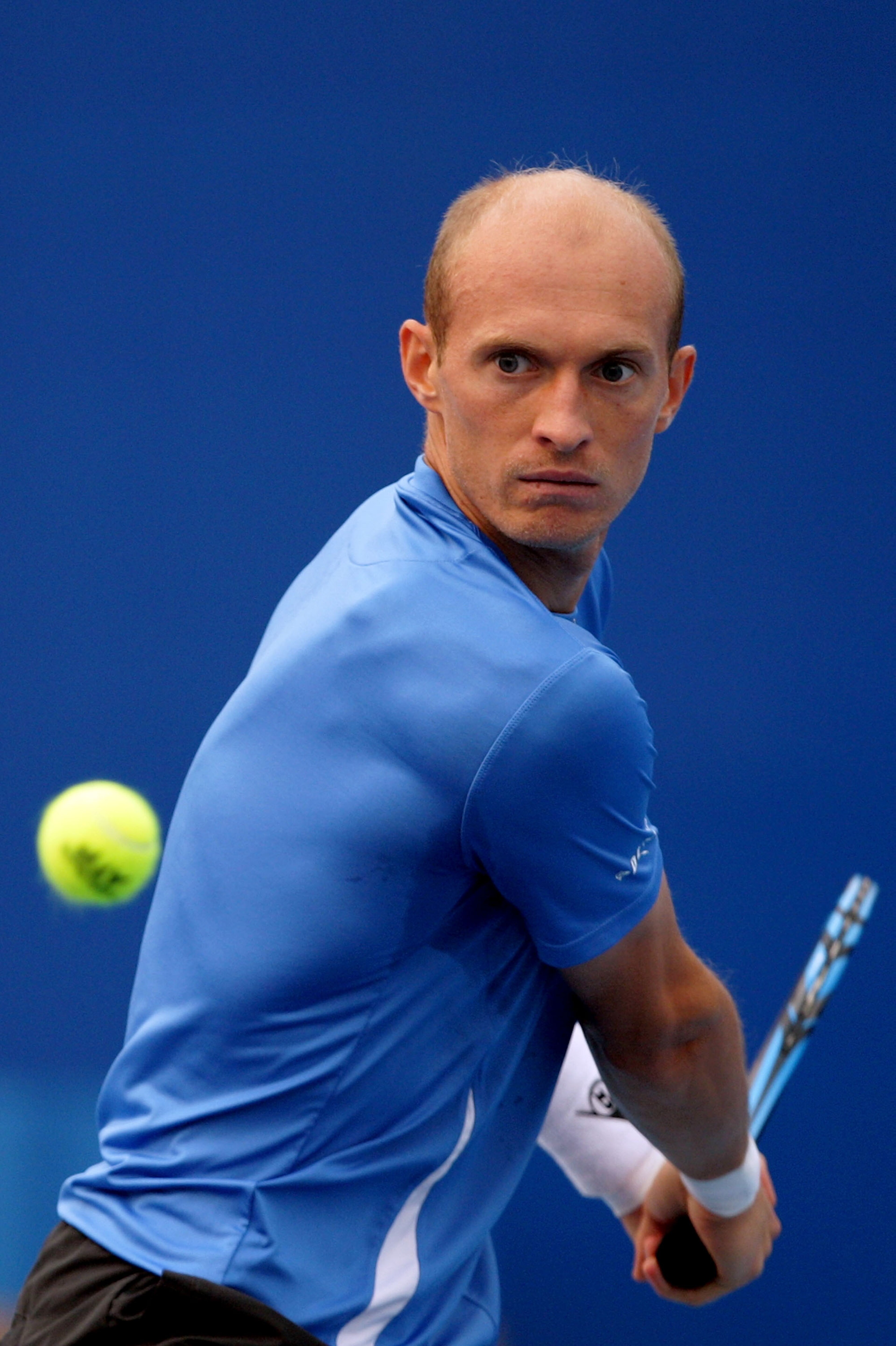 BEIJING - OCTOBER 08: Nikolay Davydenko of Russia plays a backhand during his match against John Isner of United States during day eight of the 2010 China Open at the National Tennis Center on October 8, 2010 in Beijing, China. (Photo by Lintao Zhang/G BEIJING - OCTOBER 08: Nikolay Davydenko of Russia plays a backhand during his match against John Isner of United States during day eight of the 2010 China Open at the National Tennis Center on October 8, 2010 in Beijing, China. (Photo by Lintao Zhang/G