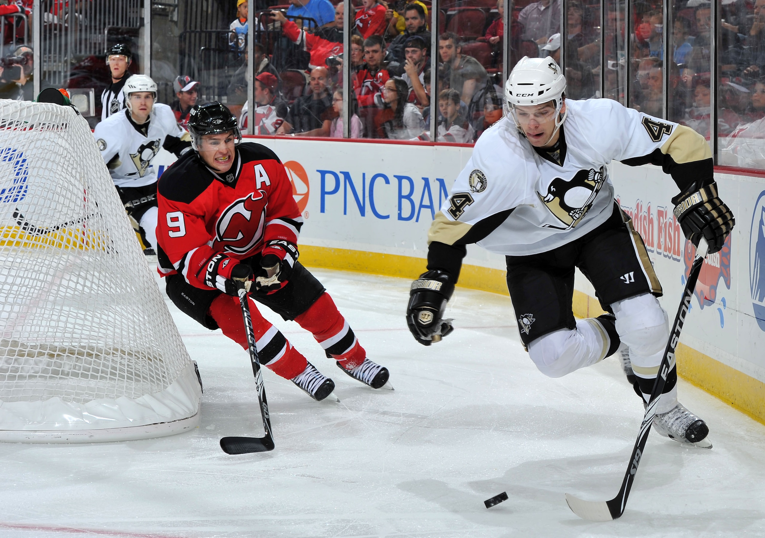 NEWARK, NJ - OCTOBER 11: Zach Parise #9 of the New Jersey Devils challenges Zbynek Michalek #4 of the Pittsburgh Penguins for possession of the puck during the second period at the Prudential Center on October 11, 2010 in Newark, New Jersey. The Penguins