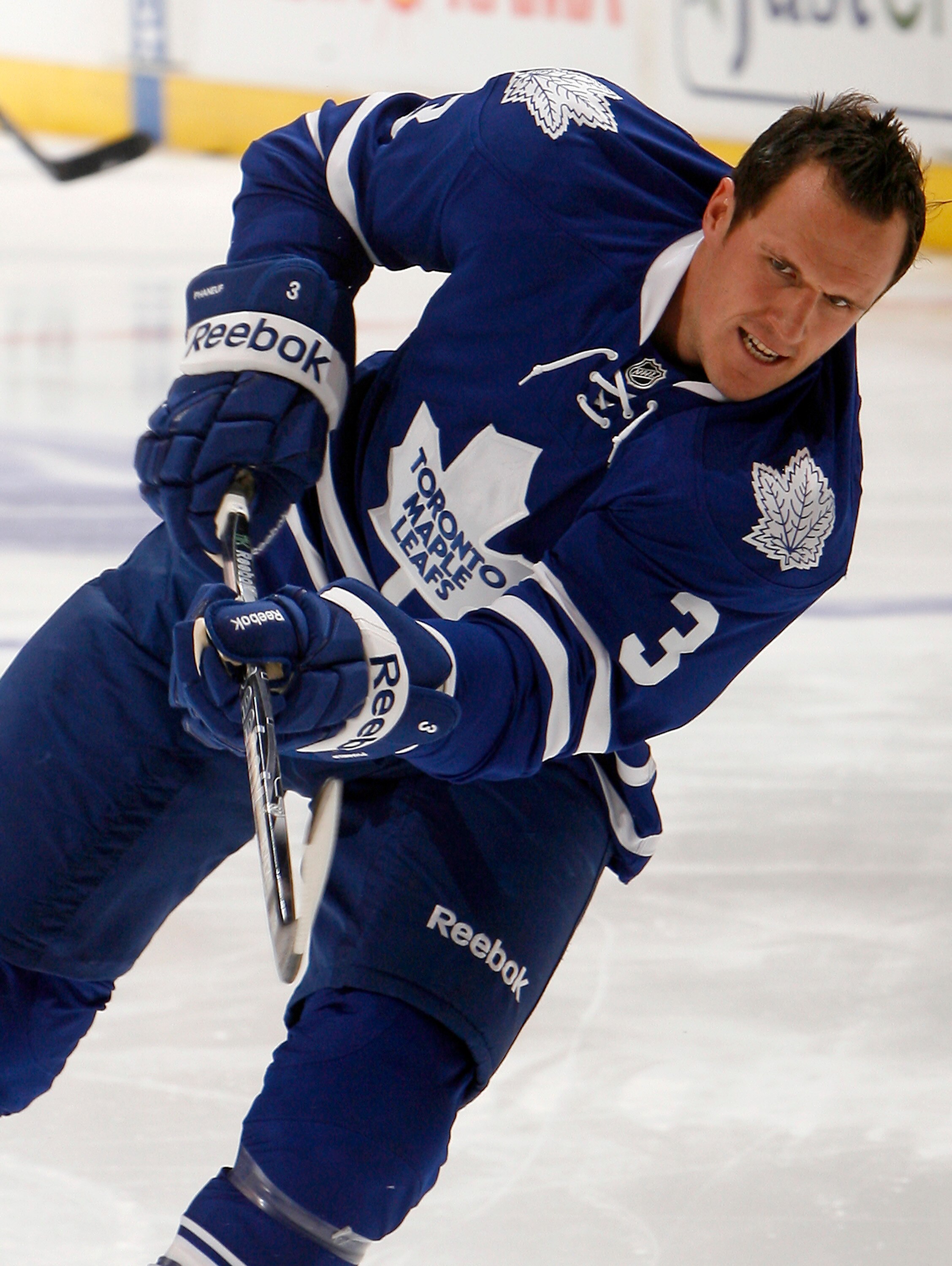 TORONTO - OCTOBER 7: First game as new Leafs Captain Dion Phaneuf #3 of the Toronto Maple Leafs shoots during warmup before playing the Montreal Canadiens during a regular season NHL game against the Toronto Maple Leafs at the Air Canada Centre October 7,