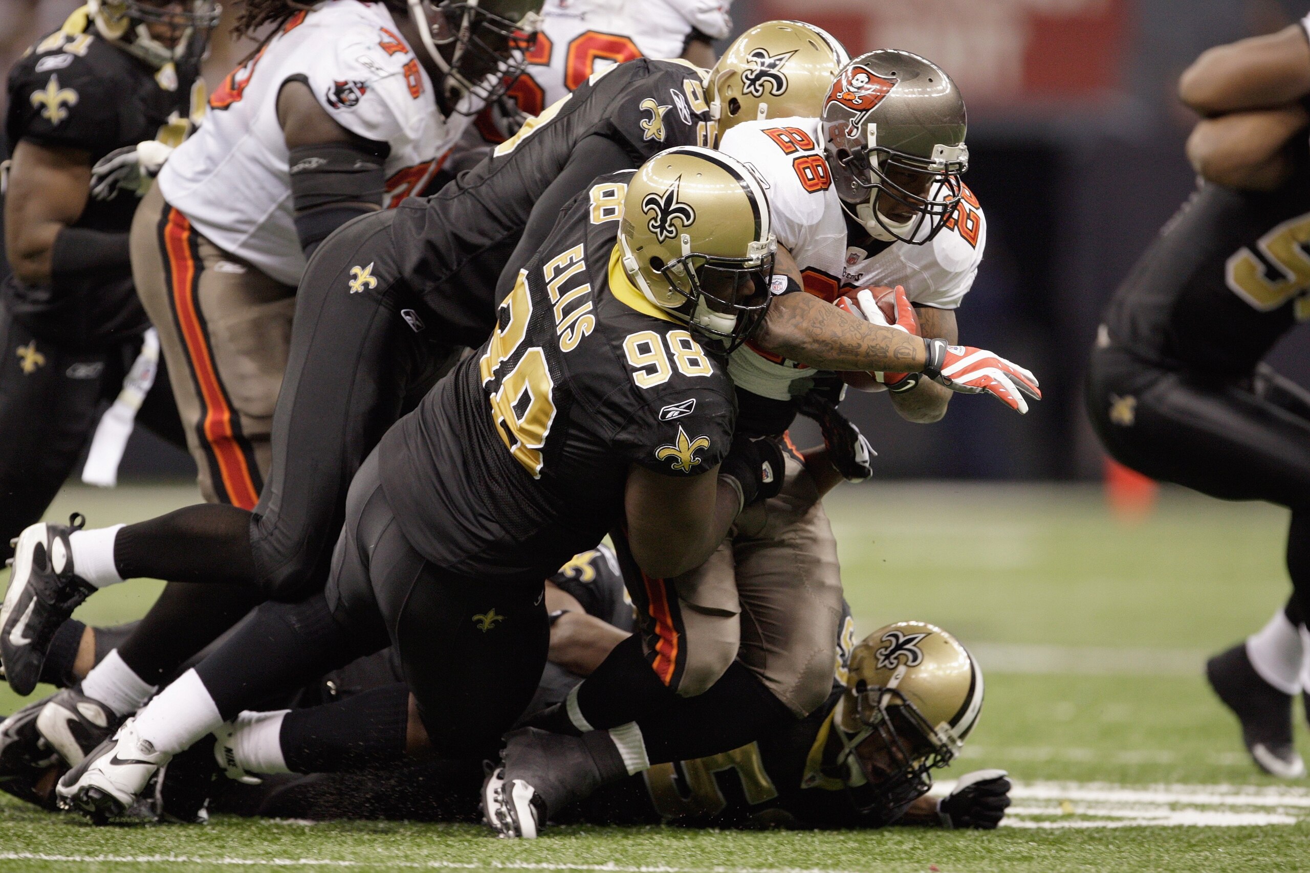 NEW ORLEANS - DECEMBER 27: Sedrick Ellis #98 of the New Orleans Saints tackles Derrick Ward #28 of the Tampa Bay Buccaneers on December 27, 2009 at Louisiana Superdome in New Orleans, Louisiana. (Photo by Jamie Squire/Getty Images)