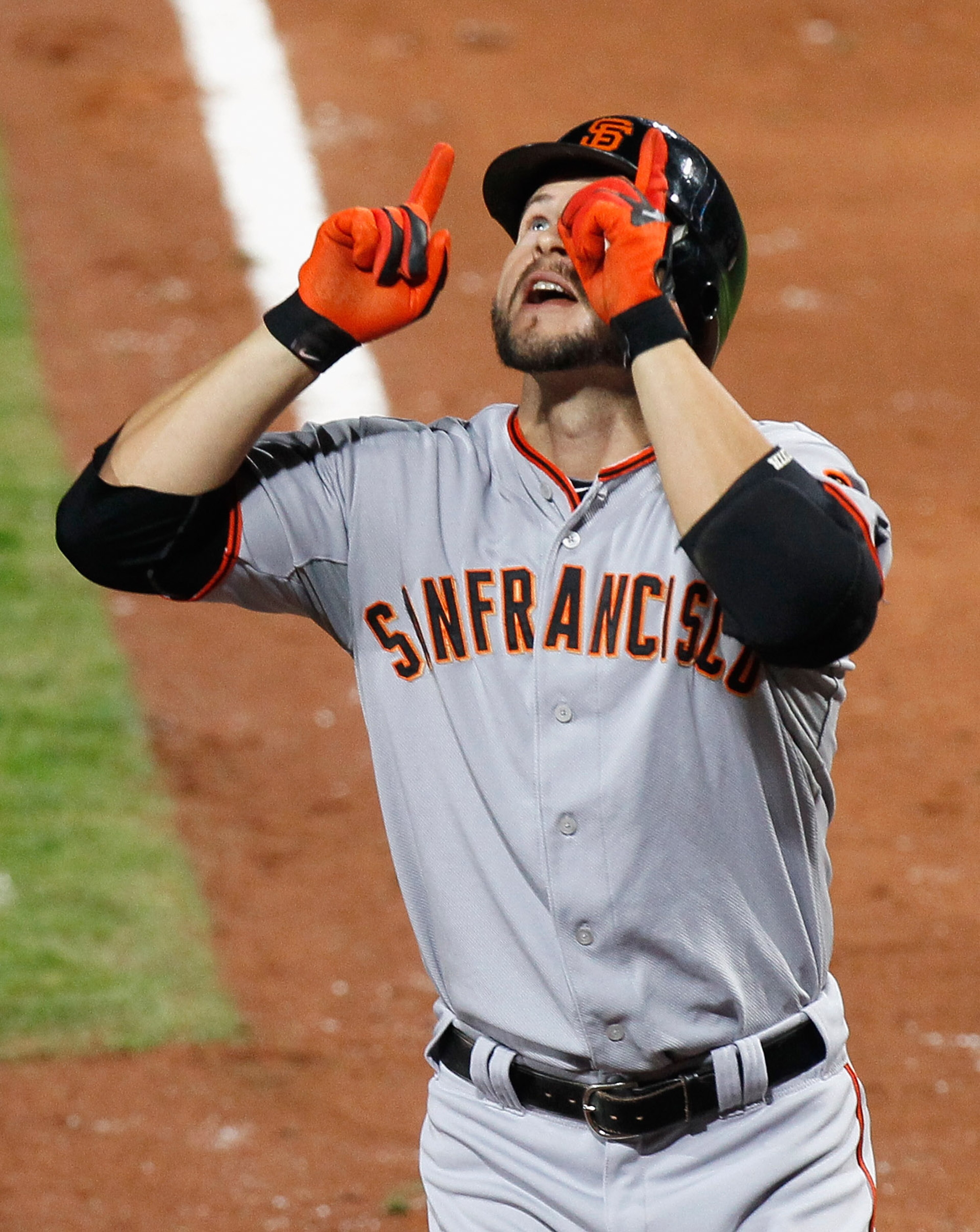 ATLANTA - OCTOBER 11:  Cody Ross #13 of the San Francisco Giants reacts after hitting a solo homer in the sixth inning against the Atlanta Braves during Game Four of the NLDS of the 2010 MLB Playoffs at Turner Field on October 11, 2010 in Atlanta, Georgia