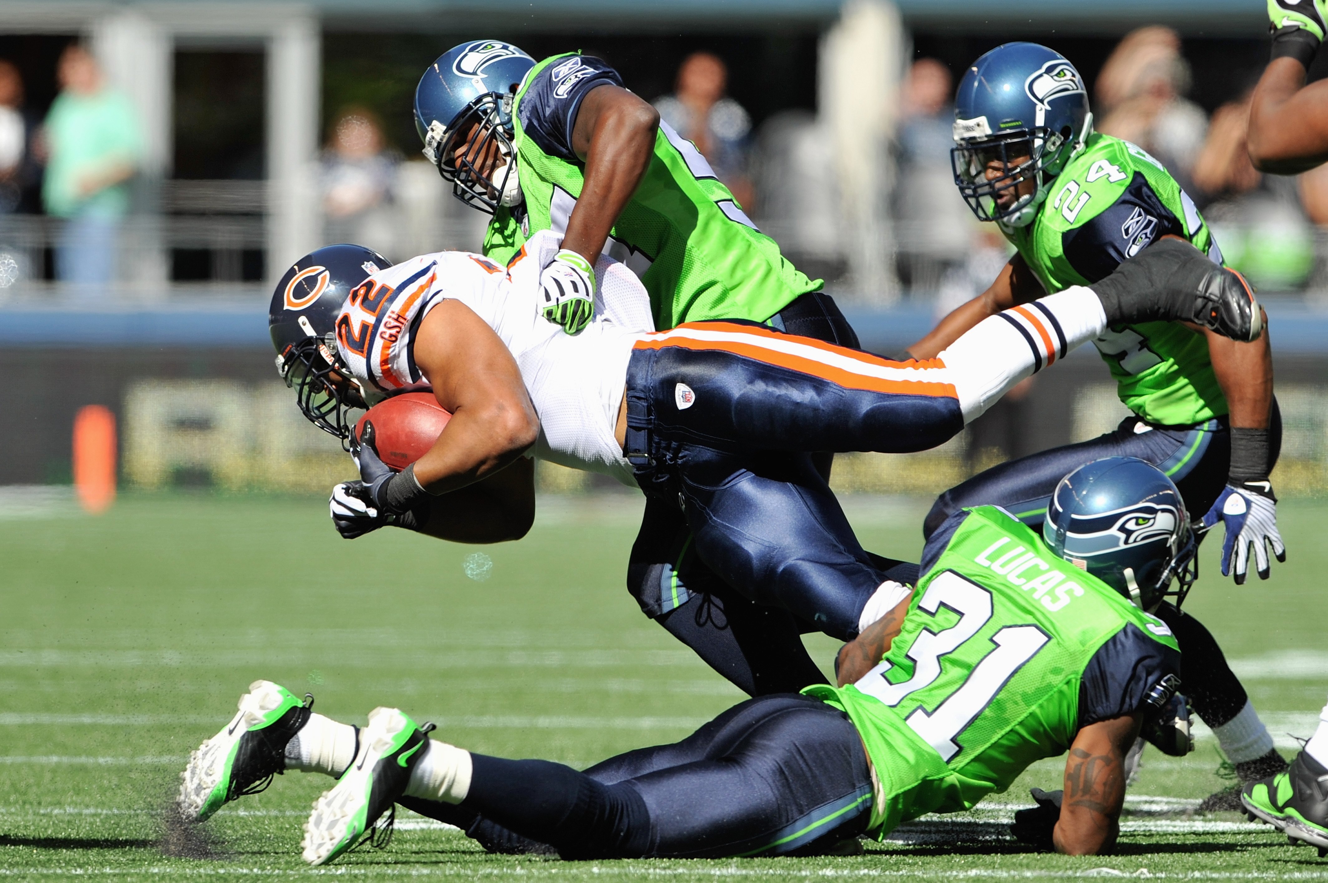SEATTLE - SEPTEMBER 27:  Matt Forte #22 of the Chicago Bears carries the ball as he is tackled during the game against the Seattle Seahawks on September 27, 2009 at Qwest Field in Seattle, Washington. The Bears defeated the Seahawks 25-19.  (Photo by Otto