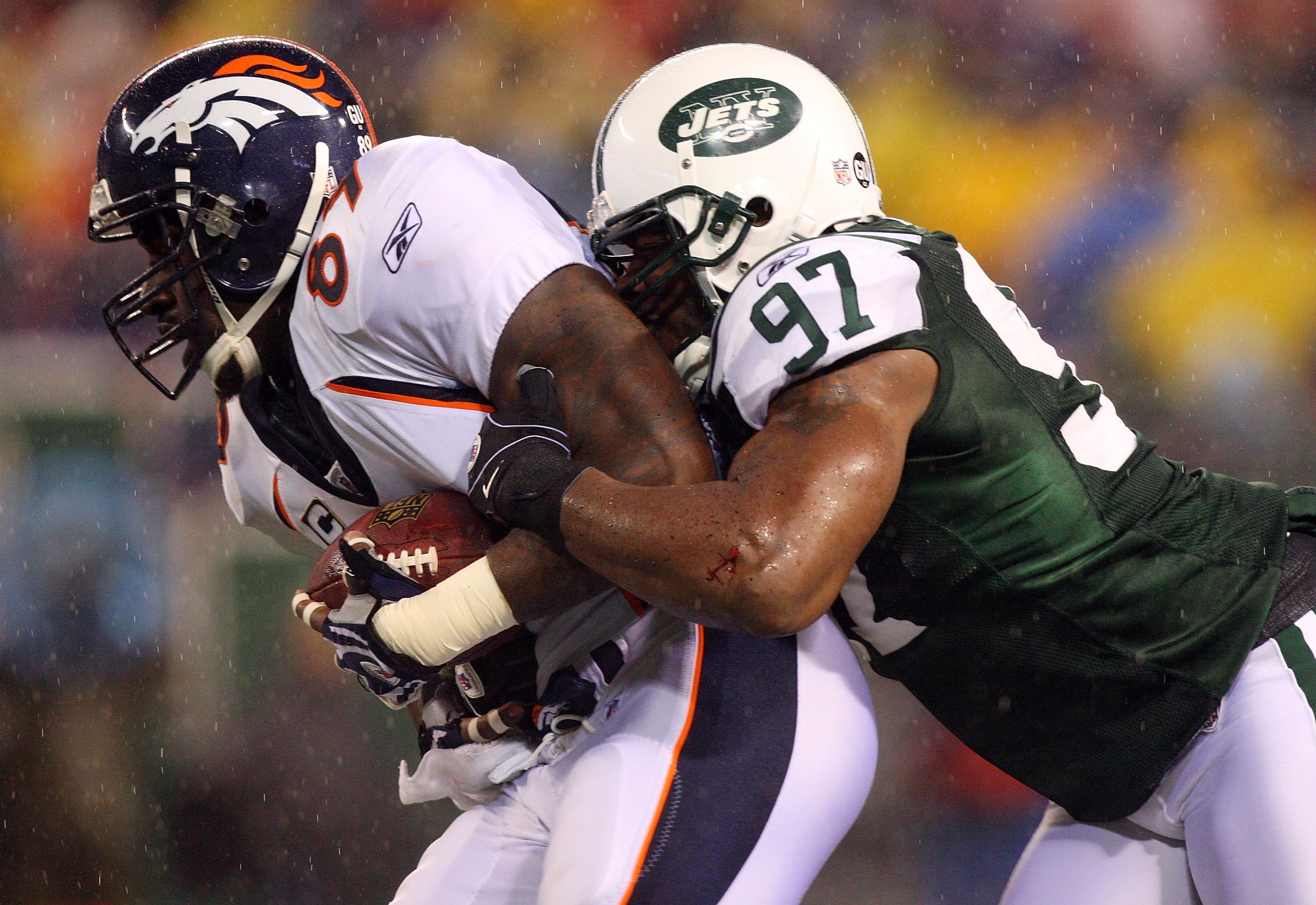 EAST RUTHERFORD, NJ - NOVEMBER 30:  Calvin Pace #97 of the New York Jets tackles Daniel Graham #89 of the Denver Broncos on November 30, 2008 at Giants Stadium in East Rutherford, New Jersey.  (Photo by Jim McIsaac/Getty Images)