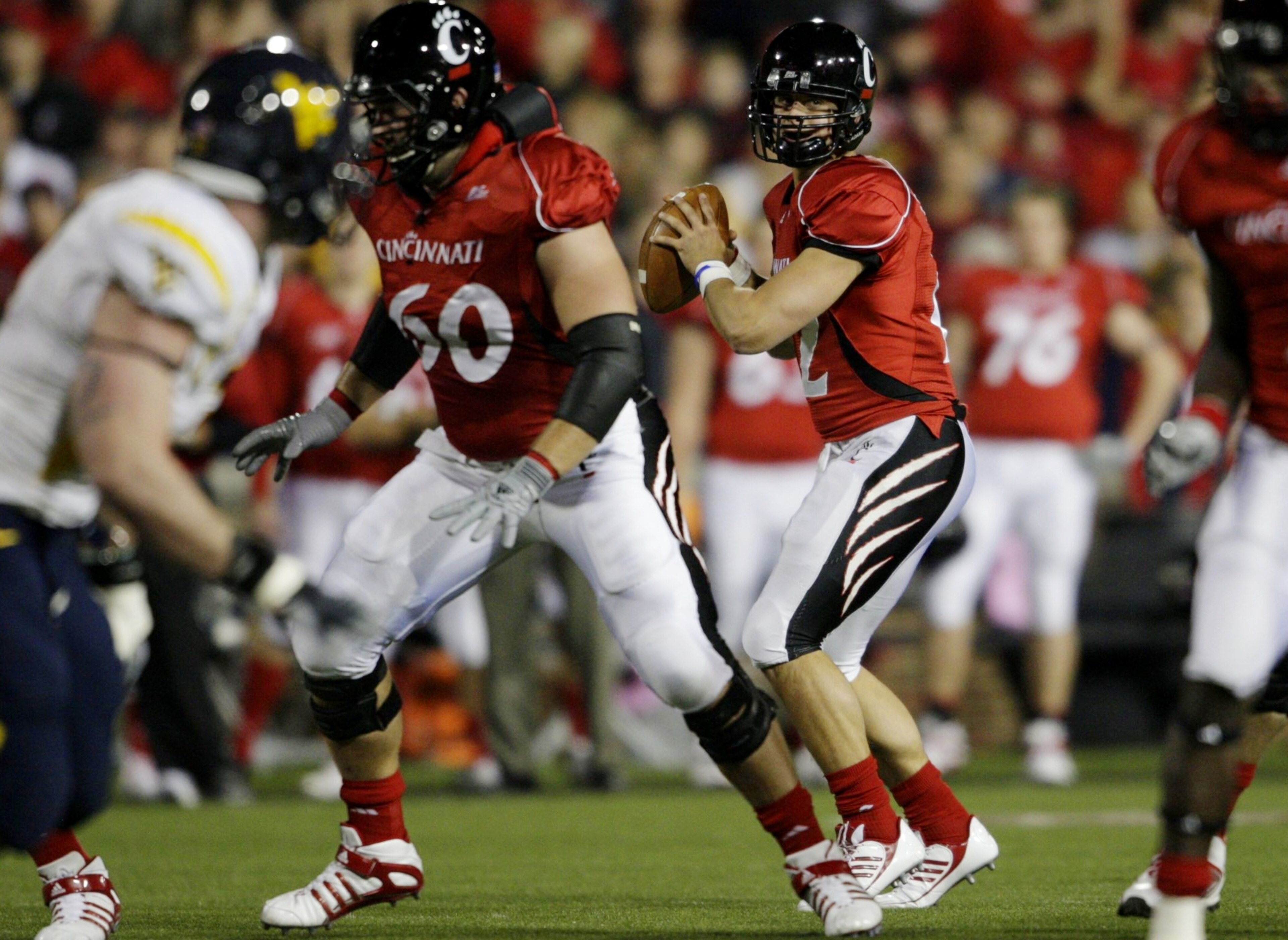 CINCINNATI - NOVEMBER 13: Quarterback Zach Collaros #12 of the the Cincinnati Bearcats looks to pass the ball in the first quarter of the game against the West Virginia Mountaineers at Nippert Stadium on November 13, 2009 in Cincinnati, Ohio.  (Photo by A