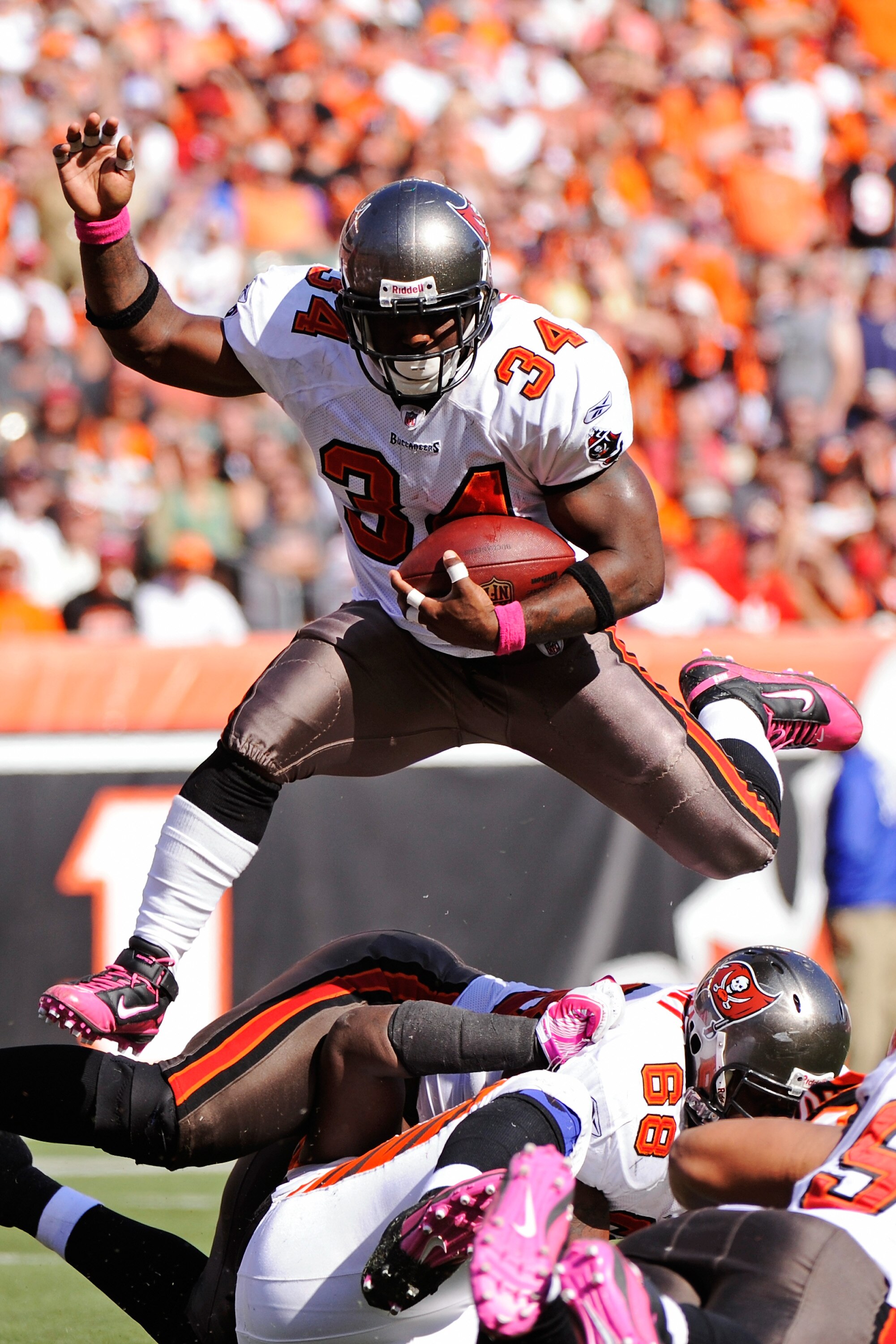 CINCINNATI, OH - OCTOBER 10:  Earnest Graham #34 of the Tampa Bay Buccaneers leaps over a pile of players on his way to a one-yard touchdown run against the Cincinnati Bengals in the third quarter at Paul Brown Stadium on October 10, 2010 in Cincinnati, O