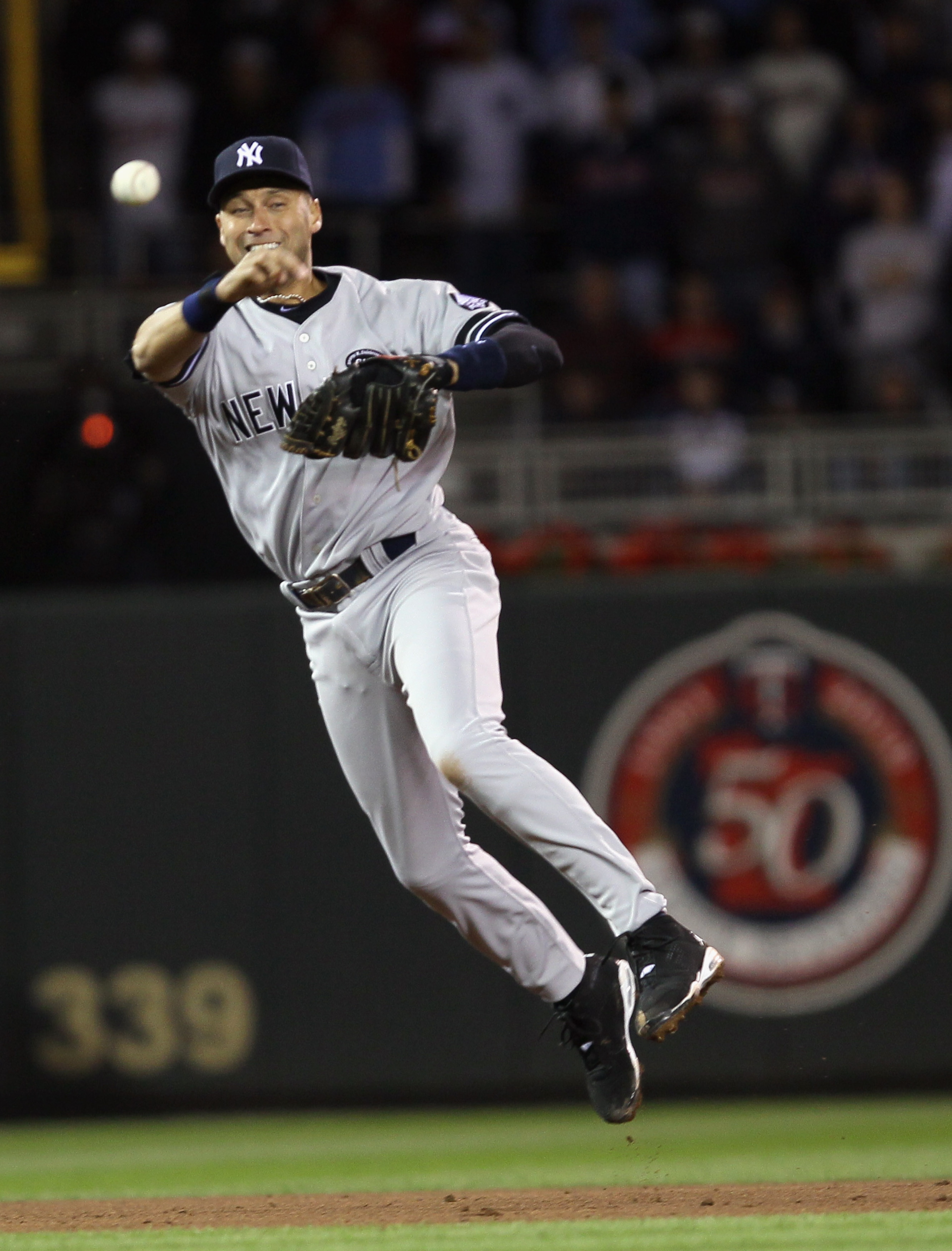 MINNEAPOLIS - OCTOBER 06:  Derek Jeter #2 of the New York Yankees sends the ball to first for the out against the Minnesota Twins during game one of the ALDS on October 6, 2010 at Target Field in Minneapolis, Minnesota. The Yankees defeated the Twins 6-4.