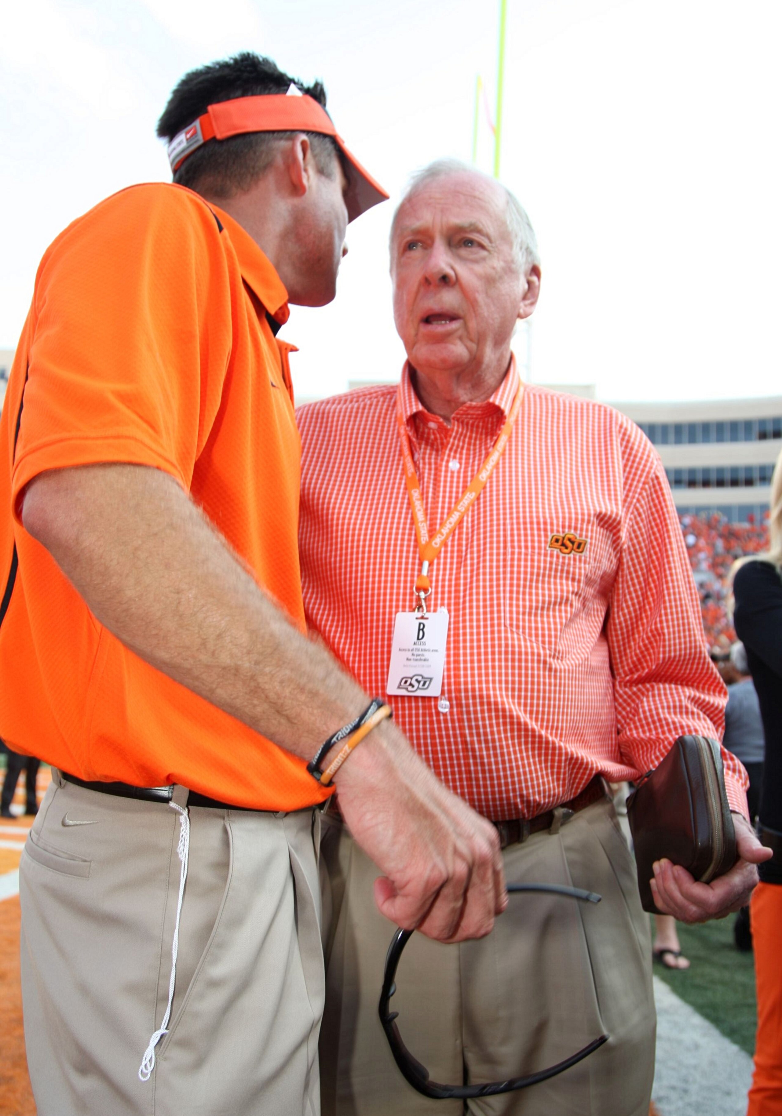 STILLWATER, OK - SEPTEMBER 5:  Boone Pickens speaks with head coach Mike Gundy of the Oklahoma State Cowboys after their 24-10 victory over the Georgia Bulldogs at Boone Pickens Stadium on September 5, 2009 in Stillwater, Oklahoma. (Photo by Christian Pet