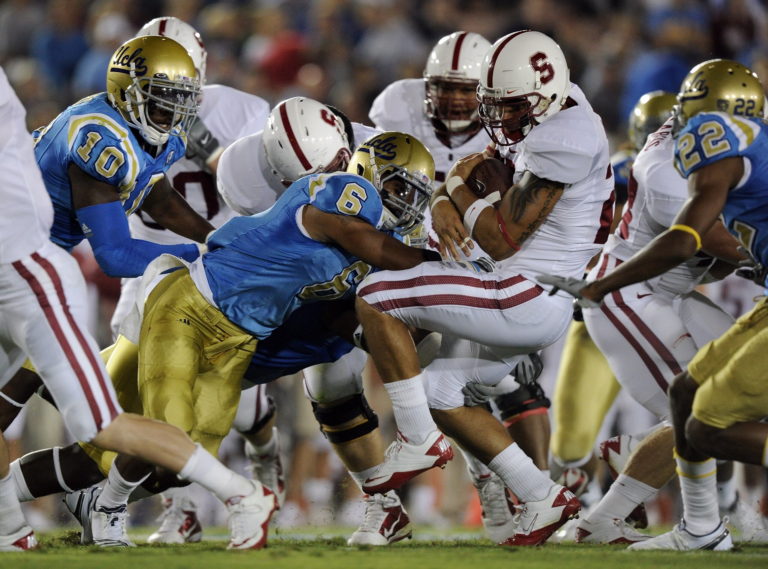 PASADENA, CA - SEPTEMBER 11:  Tyler Gaffney #25 of Stanford is hit by Tony Dye #6 of UCLA during the first quarter at the Rose Bowl on September 11, 2010 in Pasadena, California.  (Photo by Harry How/Getty Images)