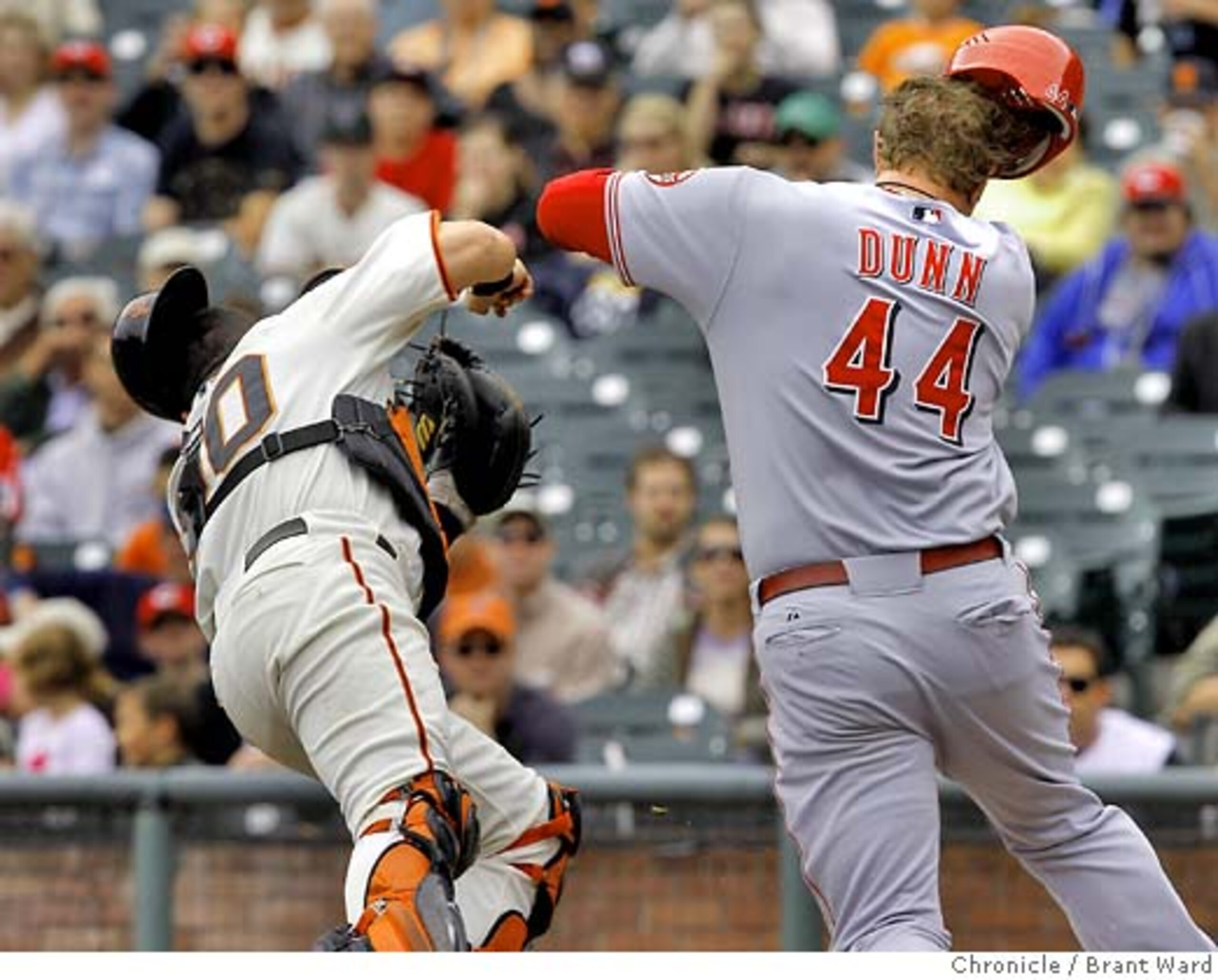 Adam Dunn plows through Giants catcher Eliezer Alfonzo.