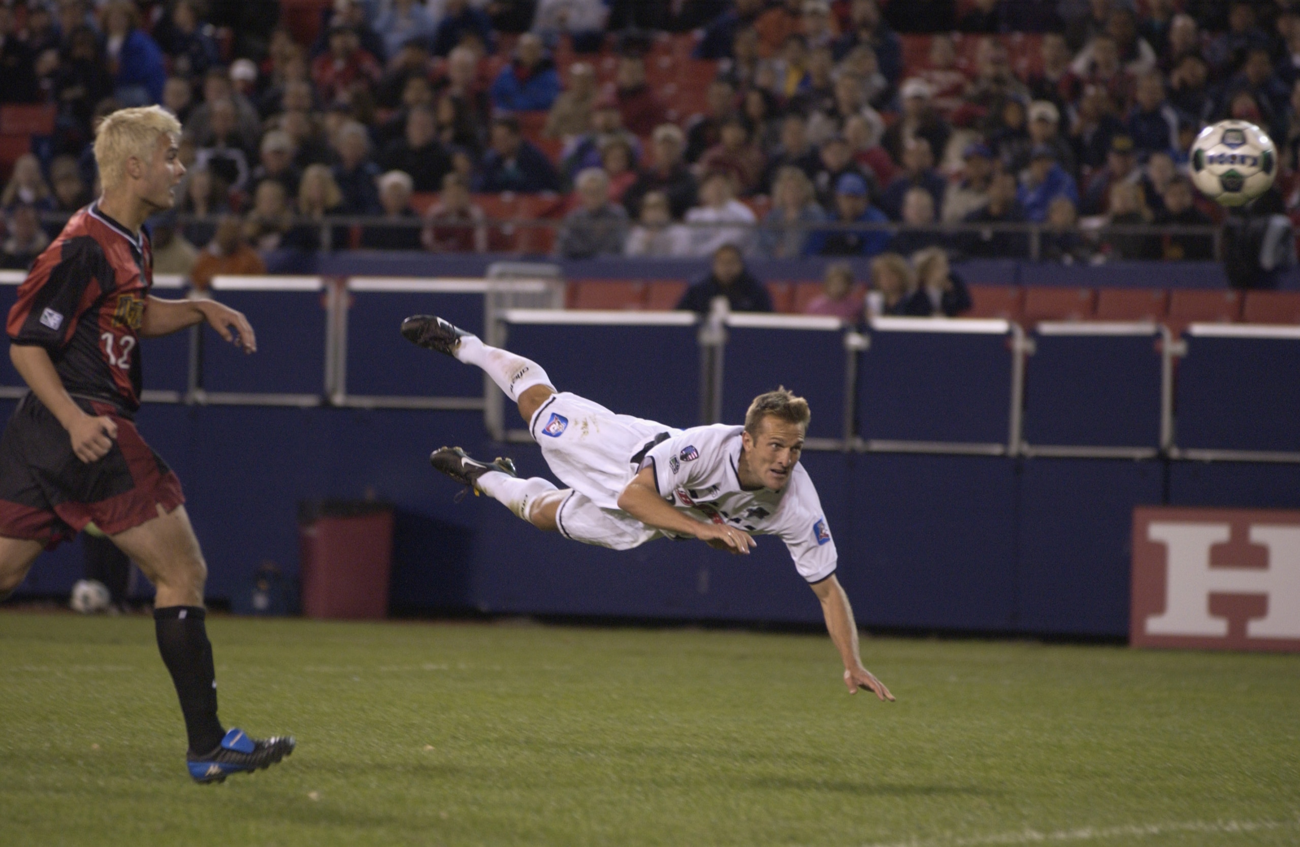 EAST RUTHERFORD - MAY  04:  Jason Kreis #9 of the Dallas Burn dives and heads the ball in for a goal while defender Mike Petke #12 of the New York/New Jersey MetroStars looks on during the MLS match at Giants Stadium in East Rutherford, New Jersey on May