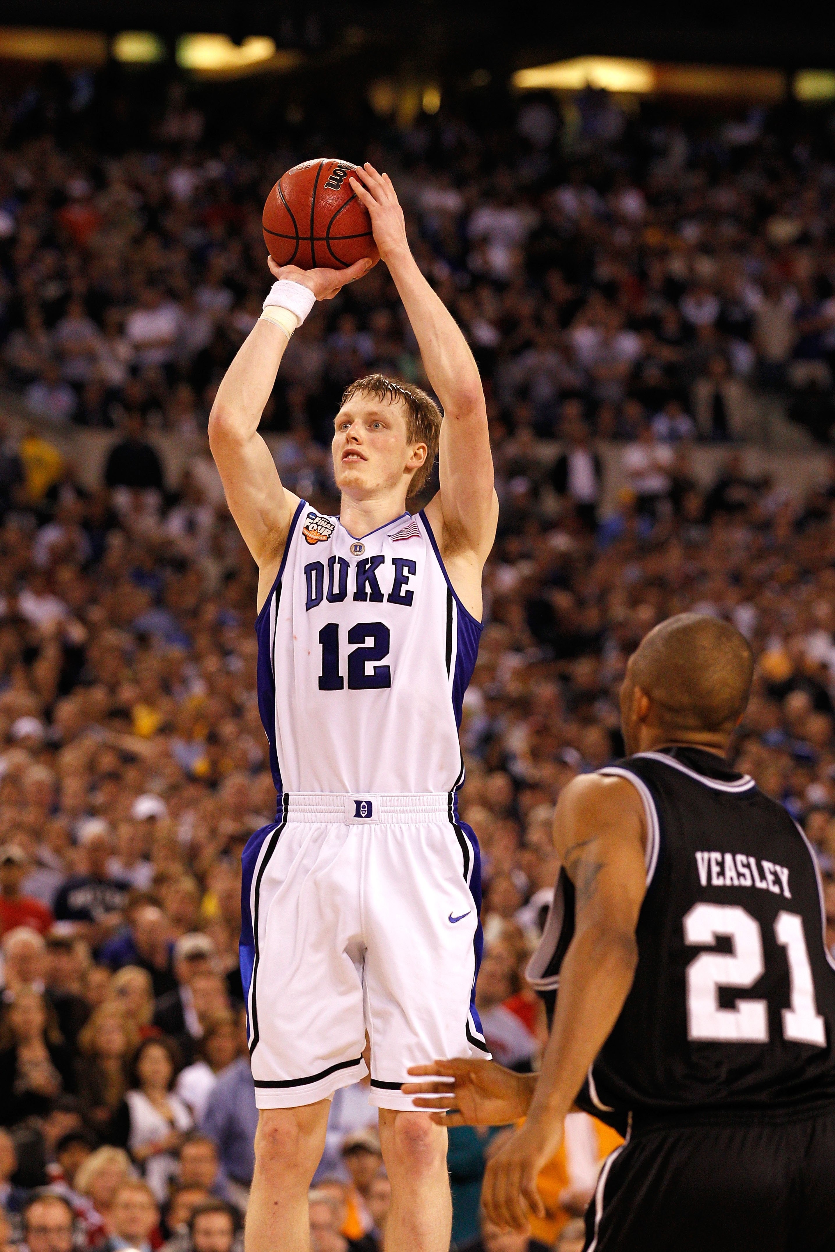 INDIANAPOLIS - APRIL 05:  Kyle Singler #12 of the Duke Blue Devils attempts a shot in the second half against the Butler Bulldogs during the 2010 NCAA Division I Men's Basketball National Championship game at Lucas Oil Stadium on April 5, 2010 in Indianap