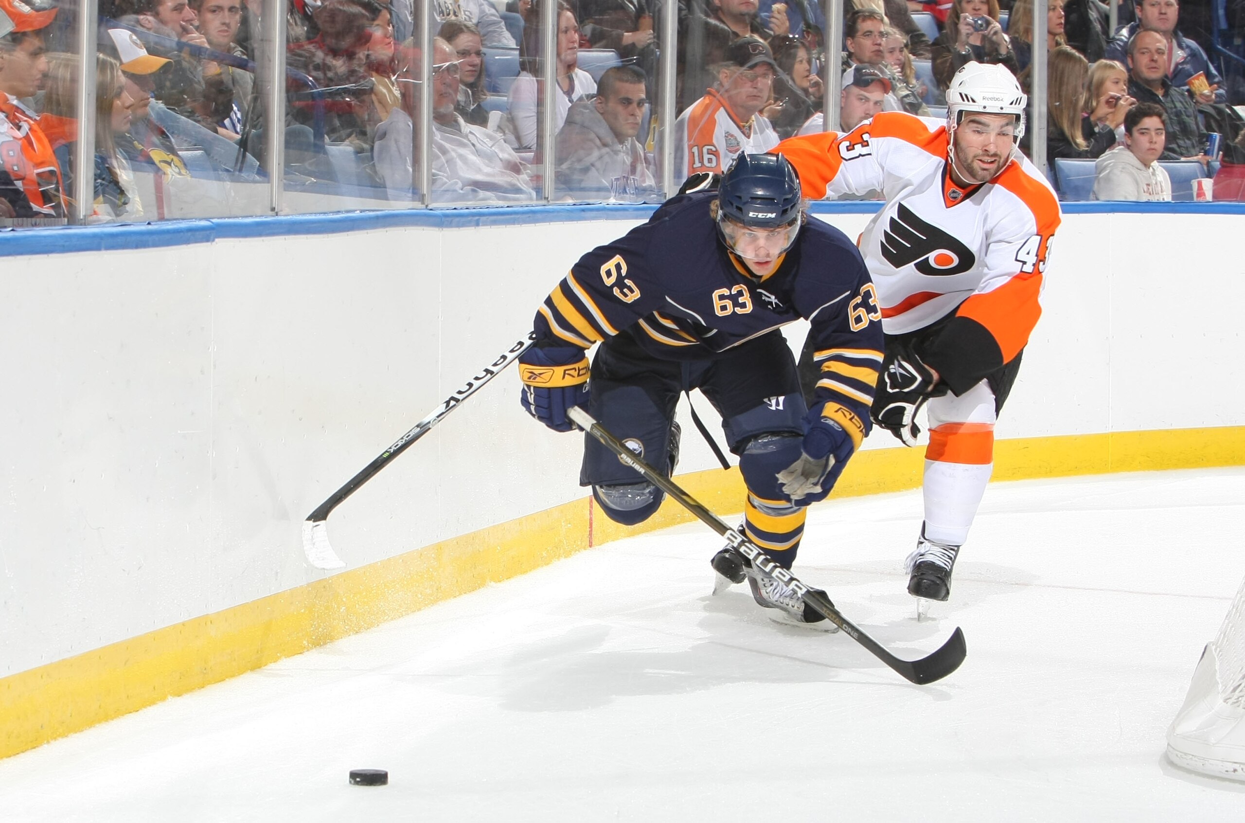 BUFFALO - OCTOBER 3:  Tyler Ennis #63 of the Buffalo Sabres battles for a loose puck with Marc-Andre Bourdon #43 of the Philadelphia Flyers during their NHL game at HSBC Arena October 3, 2010 in Buffalo, New York. The Sabres won 9-3. (Photo By Dave Sandfo