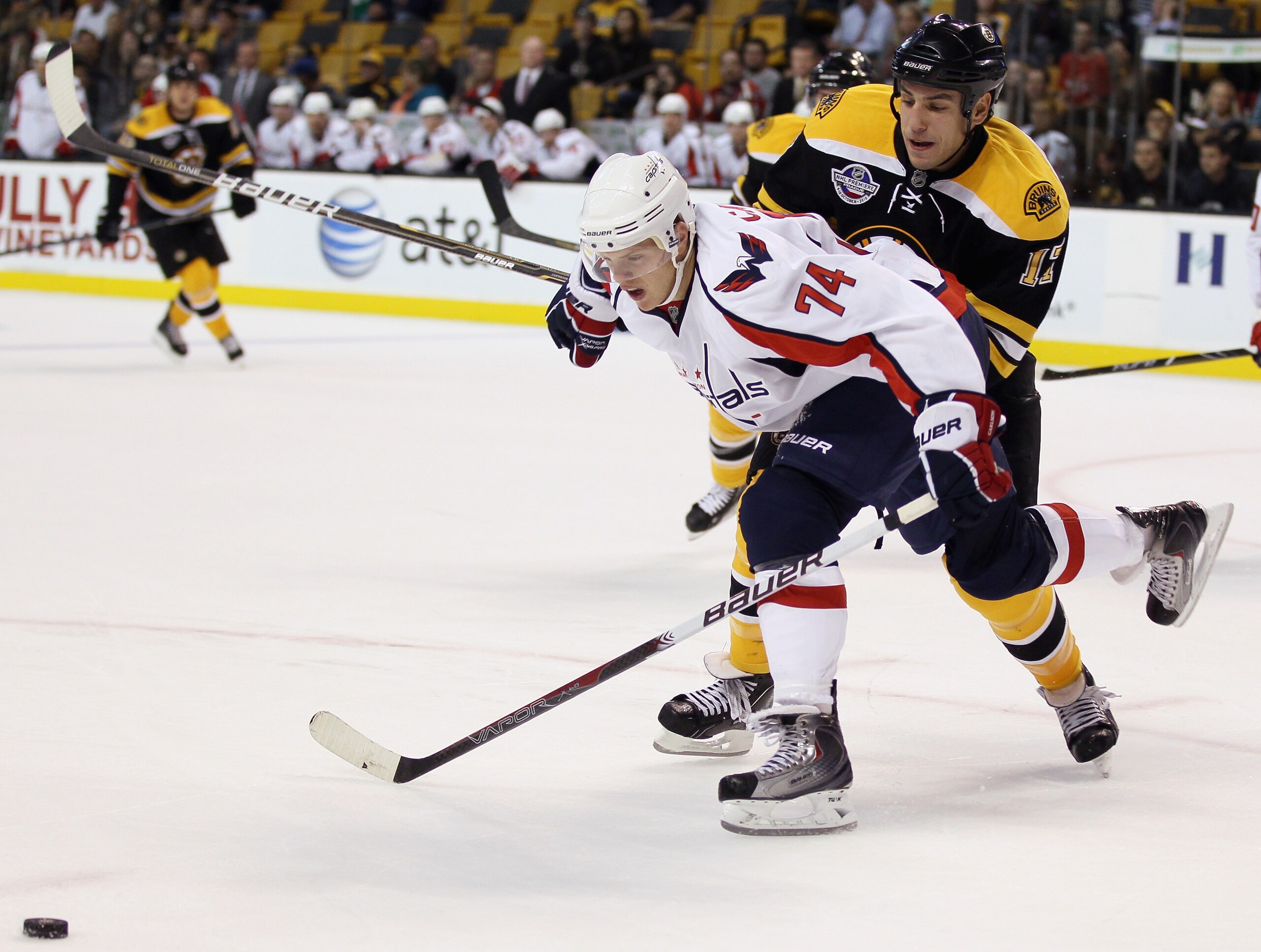 BOSTON - SEPTEMBER 29:  Milan Lucic #17 of the Boston Bruins and John Carlson #74 of the Washington Capitals fight for the puck on September 29, 2010 at the TD Garden in Boston, Massachusetts. The Capitals defeated the Bruins 4-1.  (Photo by Elsa/Getty Im