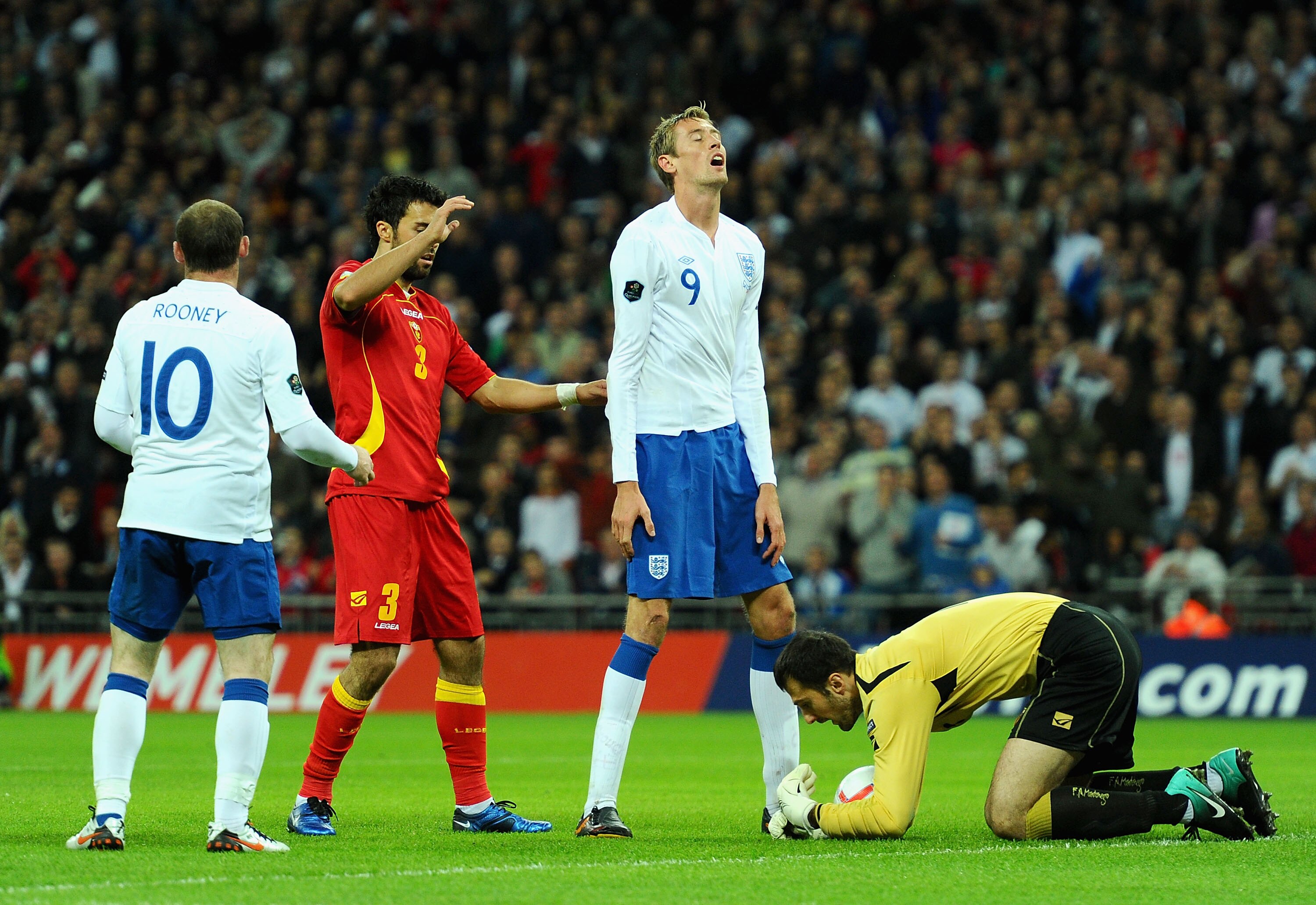 LONDON, ENGLAND - OCTOBER 12:  Peter Crouch of England shows his frustration after Mladen Bozovic of Montenegro saves his chance on goal during the UEFA EURO 2012 Group G Qualifying match between England and Montenegro at Wembley Stadium on October 12, 20