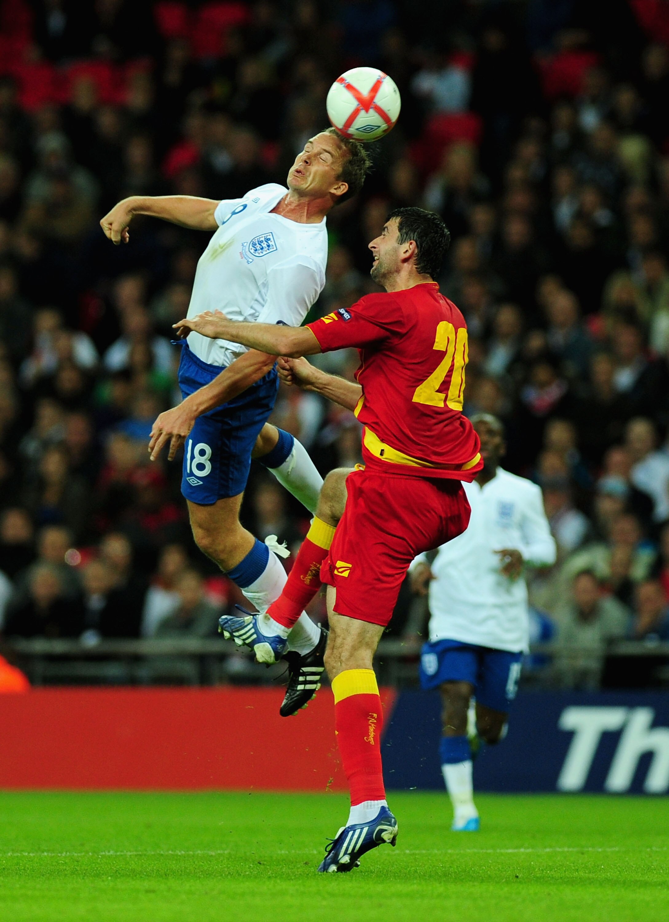 LONDON, ENGLAND - OCTOBER 12:  Kevin Davies if England and Miodrag Dzudovic of Montenegro in action during the UEFA EURO 2012 Group G Qualifying match between England and Montenegro at Wembley Stadium on October 12, 2010 in London, England.  (Photo by Mik
