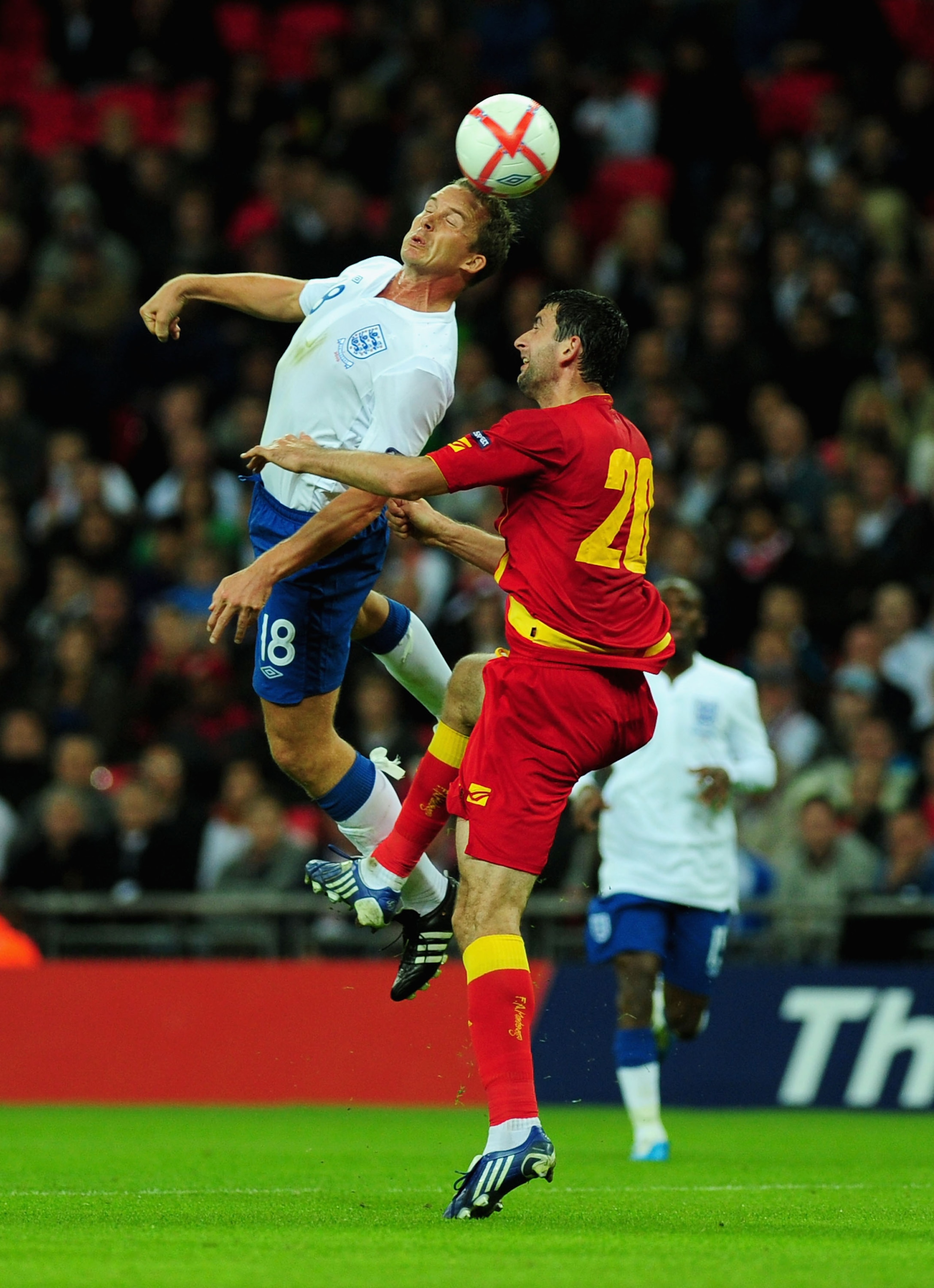 LONDON, ENGLAND - OCTOBER 12:  Kevin Davies if England and Miodrag Dzudovic of Montenegro in action during the UEFA EURO 2012 Group G Qualifying match between England and Montenegro at Wembley Stadium on October 12, 2010 in London, England.  (Photo by Mik