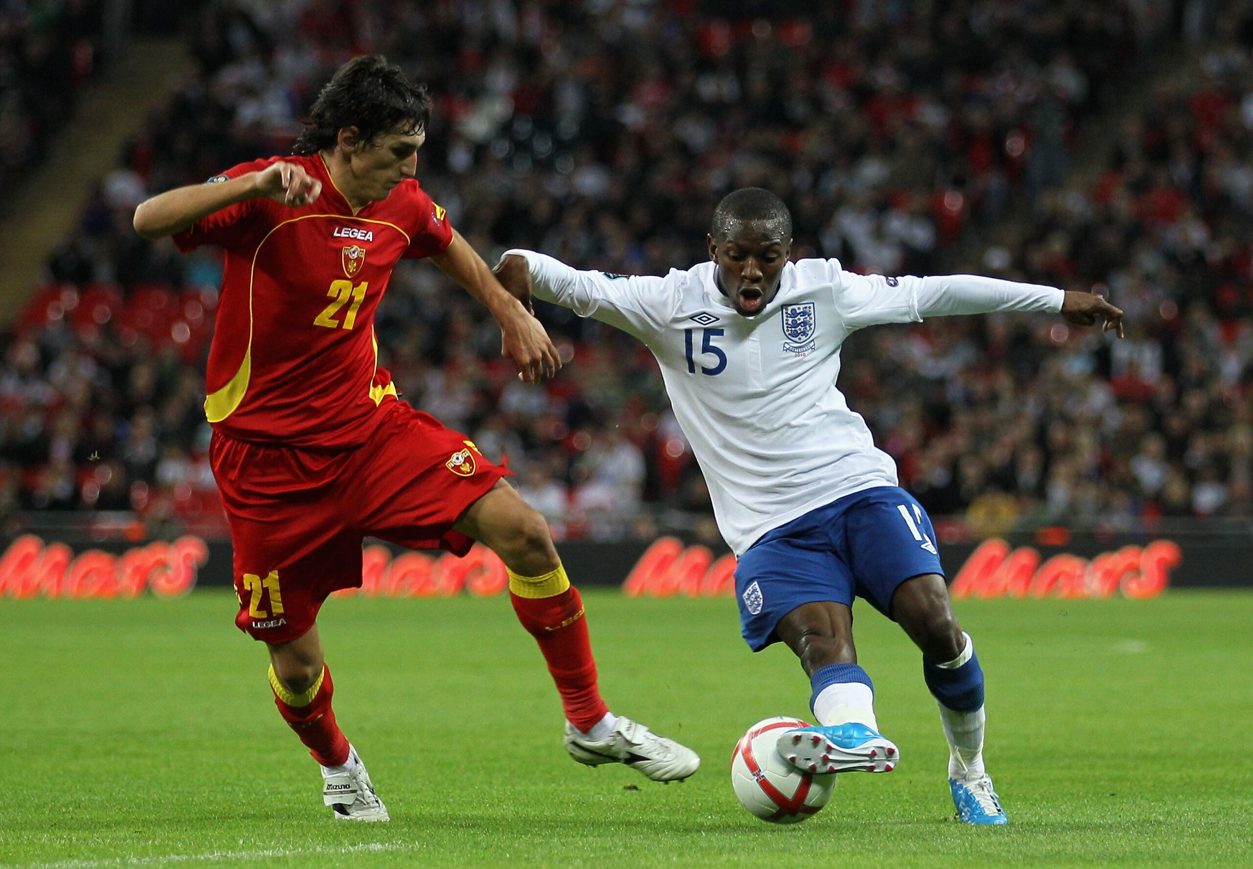 LONDON, ENGLAND - OCTOBER 12:  Shaun Wright-Phillips of England and Stefan Savic of Montenegro during the UEFA EURO 2012 Group G Qualifying match between England and Montenegro at Wembley Stadium on October 12, 2010 in London, England.  (Photo by Hamish B