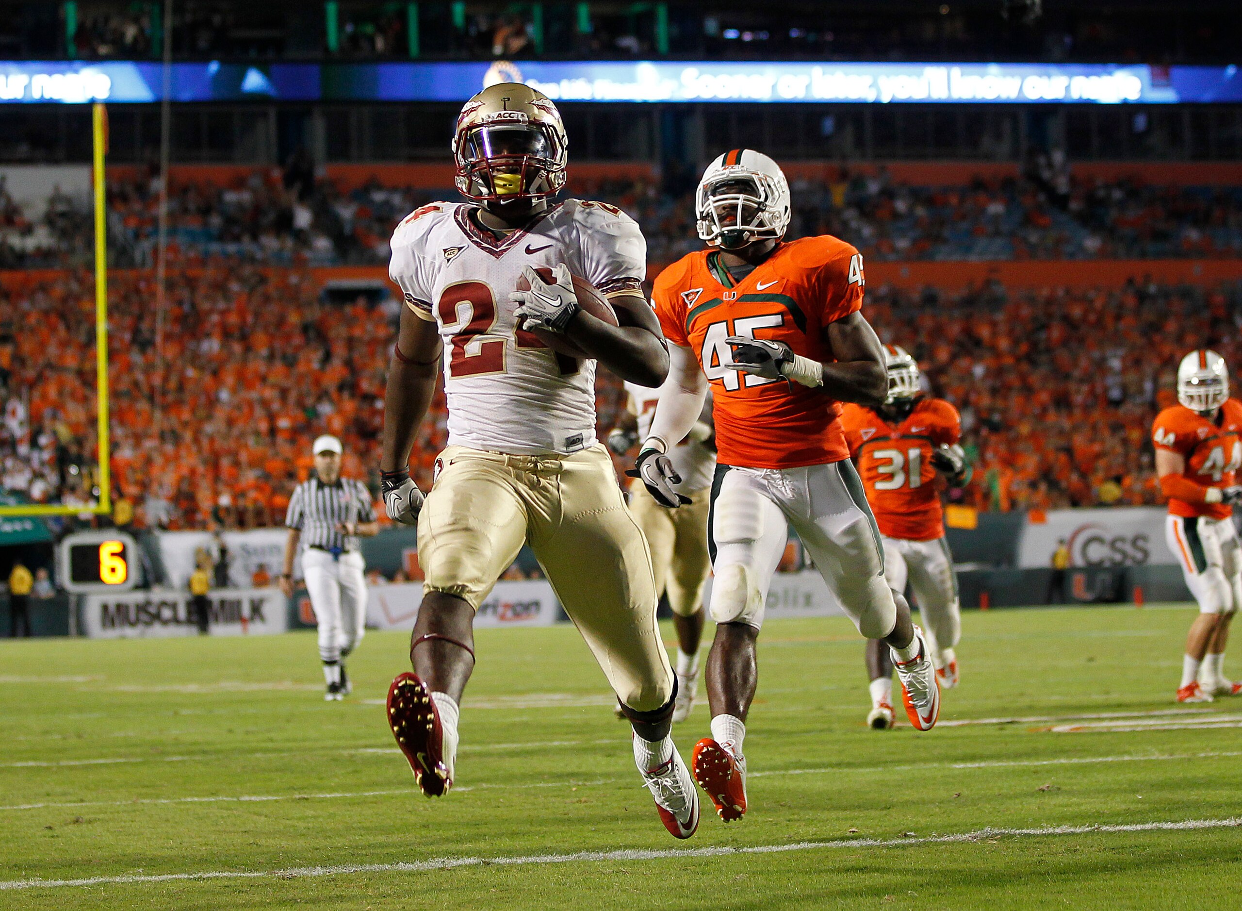 MIAMI, FL - OCTOBER 9: Lonnie Pryor #24 of the Florida State Seminoles scores a touchdown while being pursued by Ramon Buchanan #45 of the Miami Hurricanes on October 9, 2010 at Sun Life Stadium in Miami, Florida. The Seminoles defeated the Hurricanes 45-
