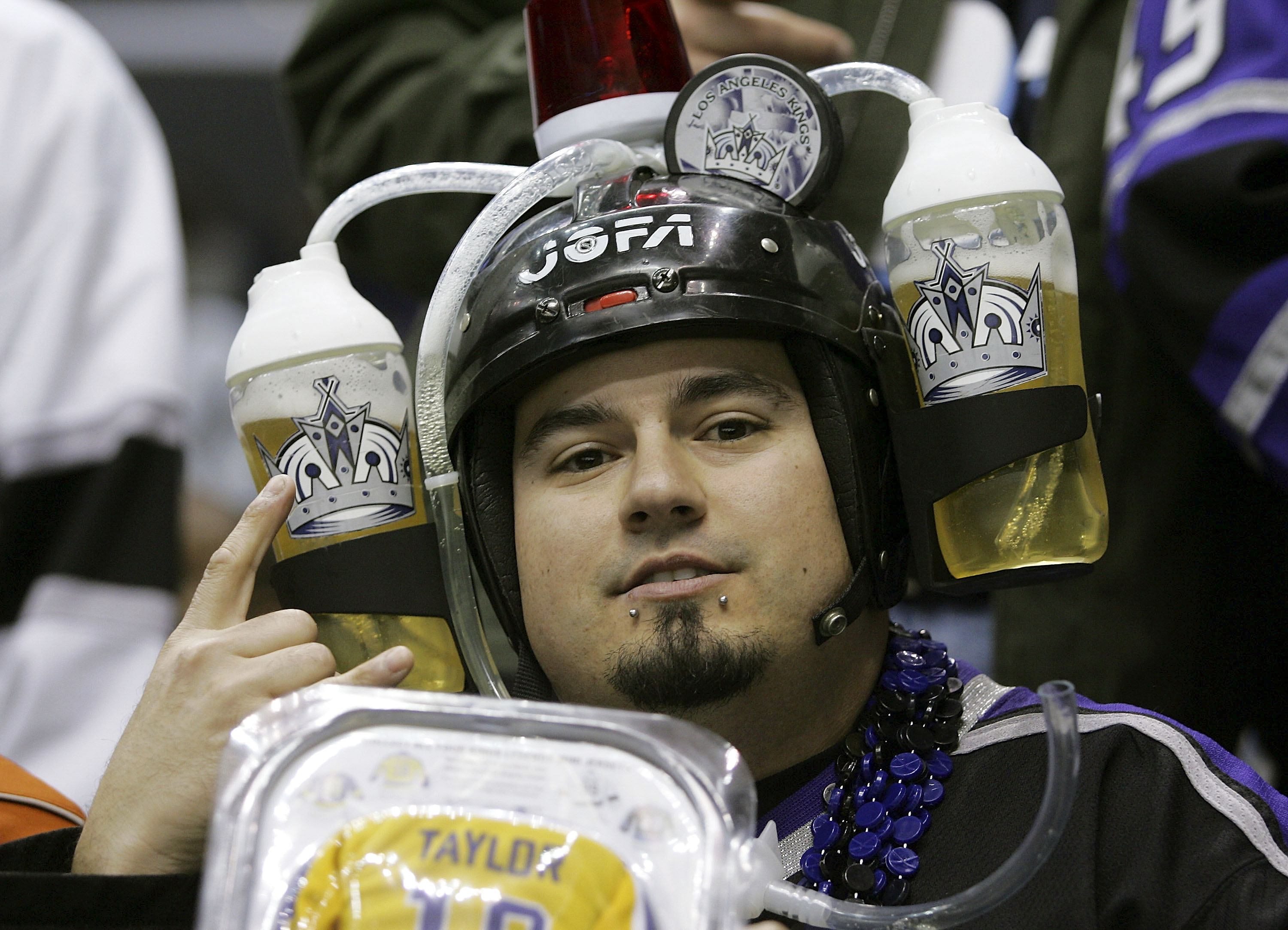 LOS ANGELES - FEBRUARY 1:  A fan of the Los Angeles Kings sports a 'beer helmet' during the Kings game against the Chicago Blackhawks at the Staples Center on February 1, 2007 in Los Angeles, California. (Photo by Bruce Bennett/Getty Images)