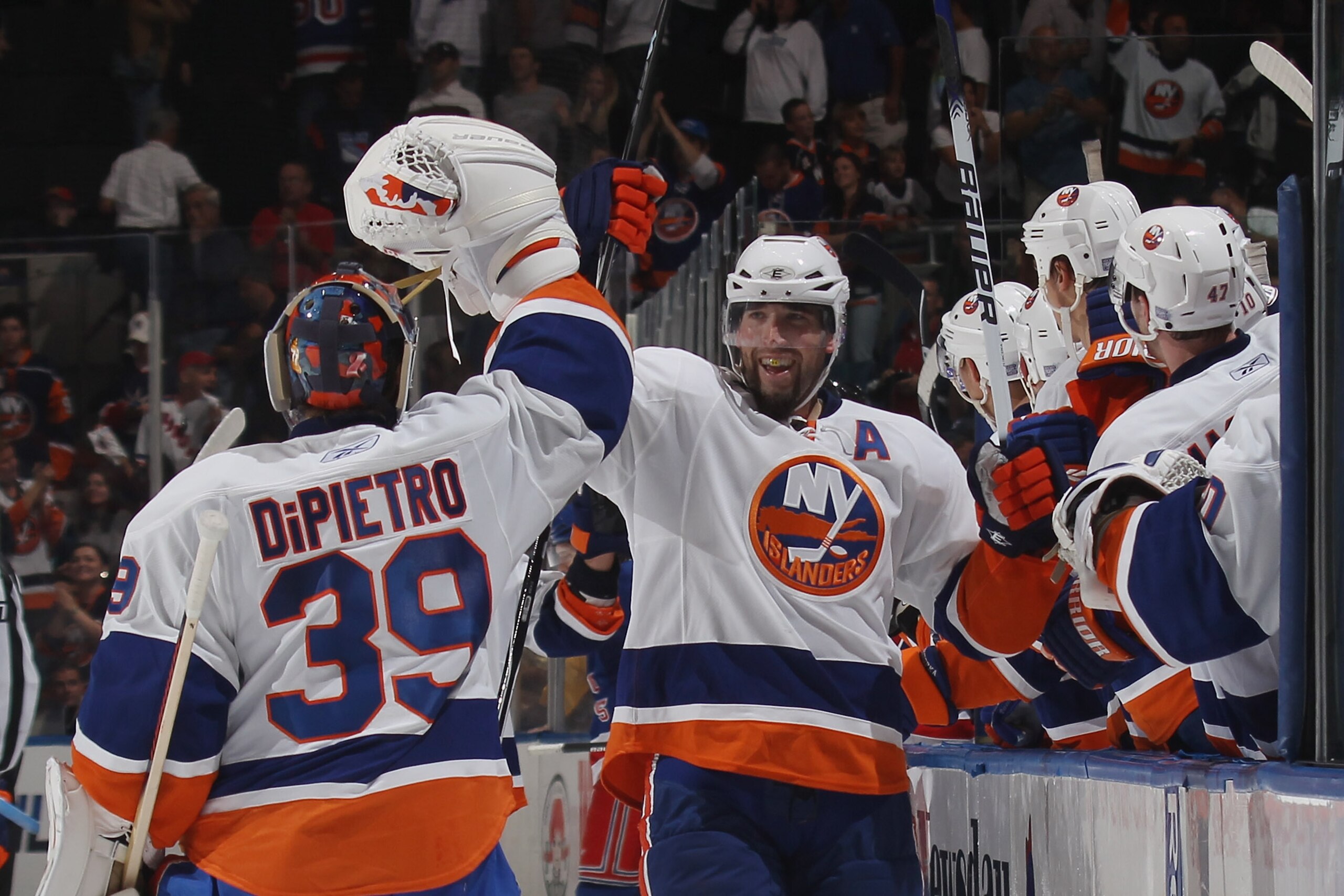 UNIONDALE, NY - OCTOBER 11: Trent Hunter #7  of the New York Islanders high fives Rick DiPietro #39 following the Islanders go ahead goal in the third period against the New York Rangers at the Nassau Coliseum on October 11, 2010 in Uniondale, New York. (