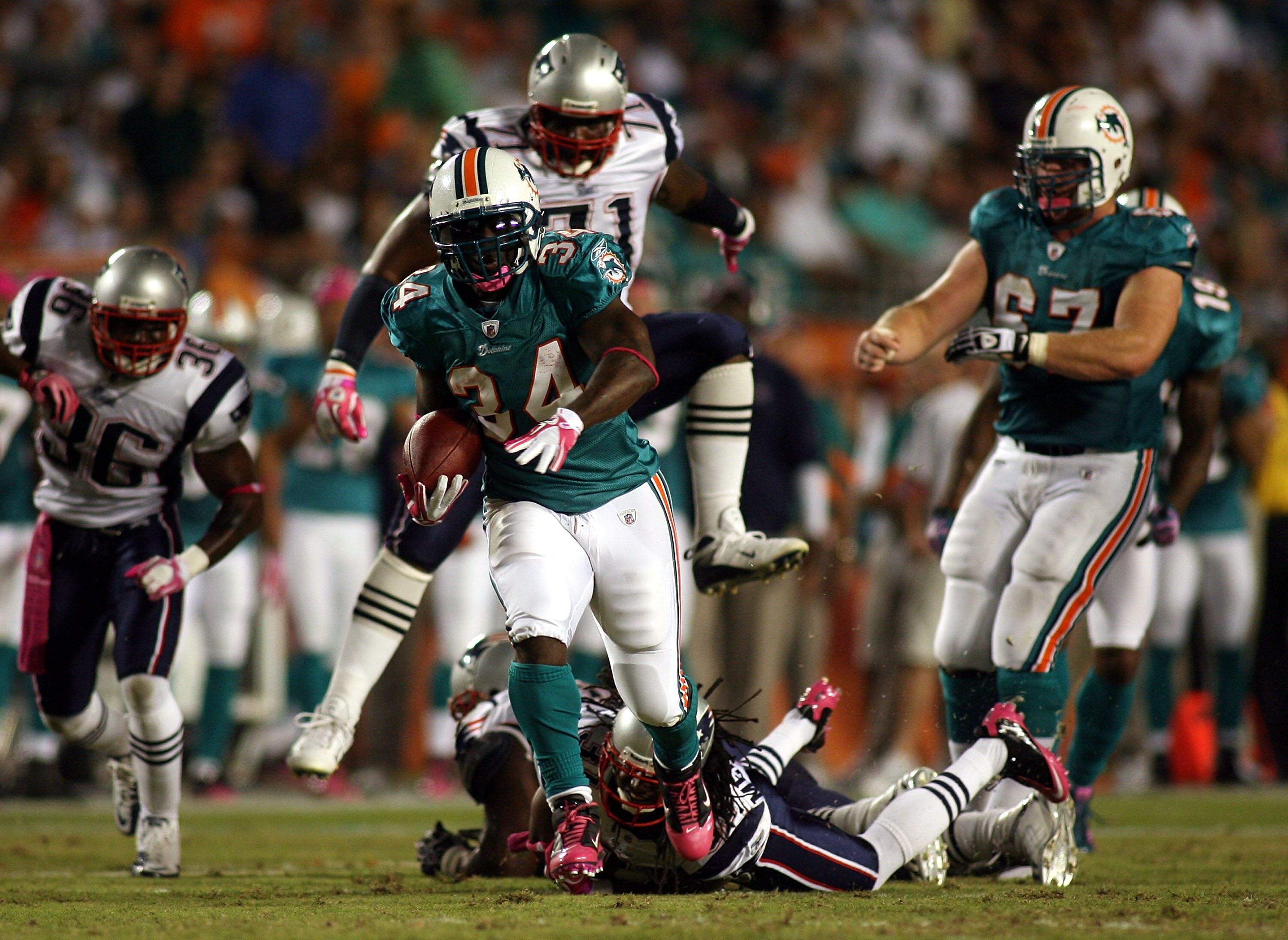 MIAMI - OCTOBER 04:  Running back Ricky Williams #34 of the Miami Dolphins runs against the New England Patriots at Sun Life Stadium on October 4, 2010 in Miami, Florida.  (Photo by Marc Serota/Getty Images)