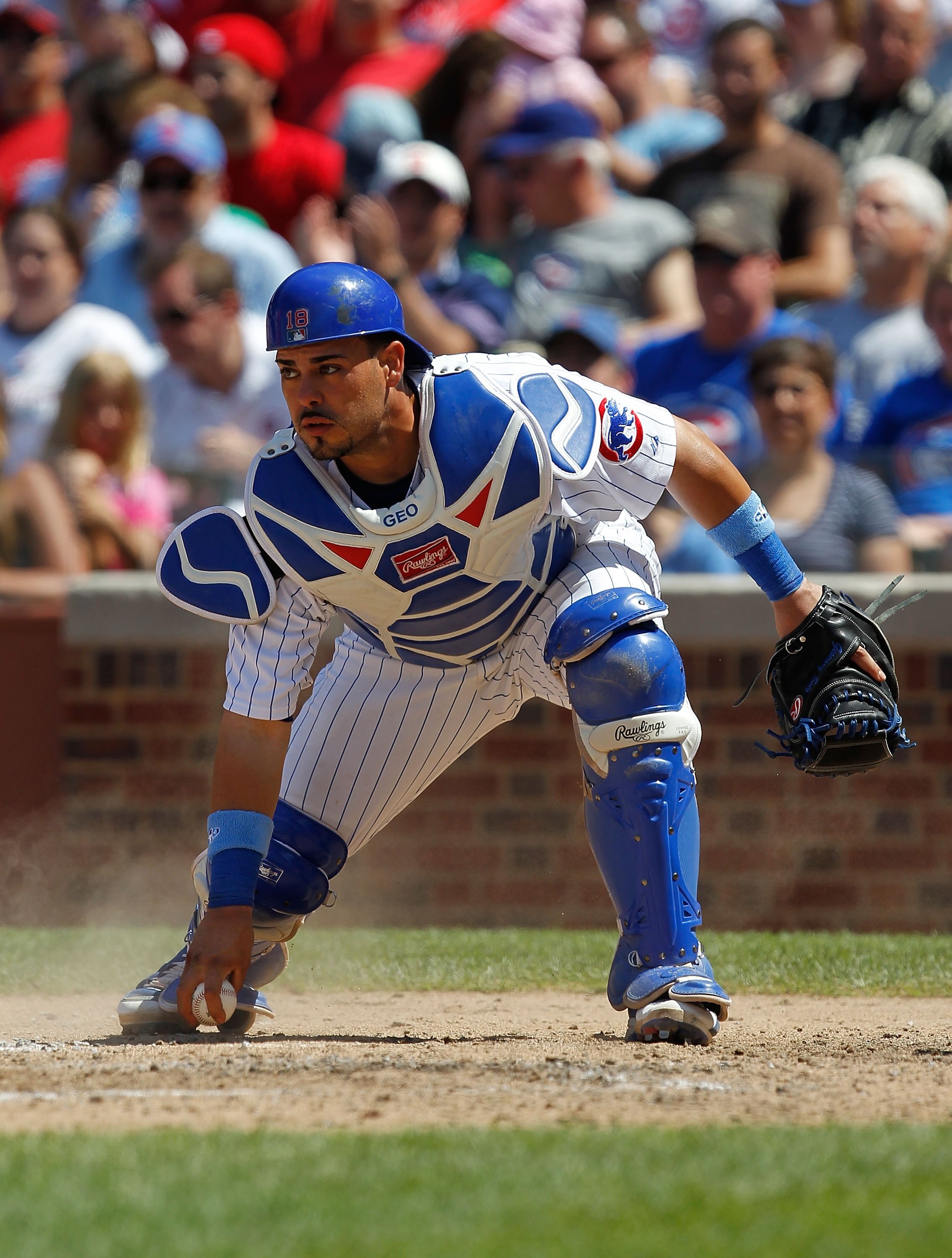 CHICAGO - JUNE 20: Geovany Soto #18 of the Chicago Cubs picks up the ball against the Los Angeles Angels of Anaheim at Wrigley Field on June 20, 2010 in Chicago, Illinois. The Cubs defeated the Angels 12-1. (Photo by Jonathan Daniel/Getty Images)