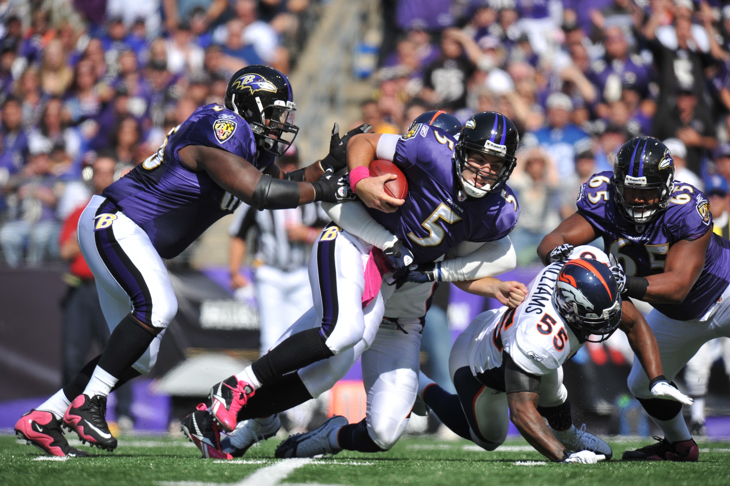 BALTIMORE, MD - OCTOBER 10:  Joe Flacco #5 of the Baltimore Ravens runs the ball against the Denver Broncos at M&T Bank Stadium on October 10, 2010 in Baltimore, Maryland. Players wore pink in recognition of Breast Cancer Awareness Month. The Ravens lead 