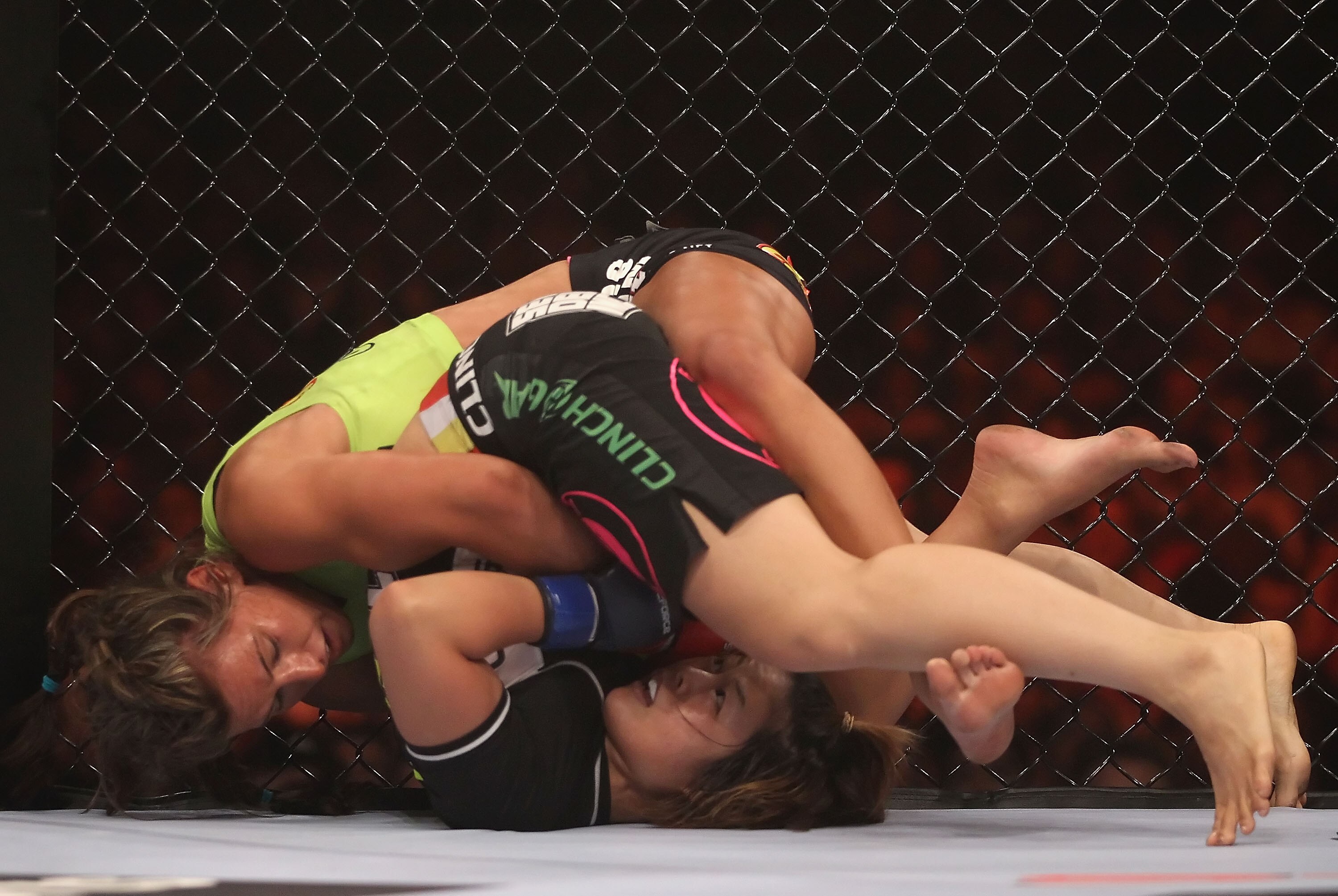 PHOENIX - AUGUST 13:  Miesha Tate (top) battles with Hitomi Akano of Japan in the Strikeforce Women's Welterweight Tournament Championship bout at Dodge Theater on August 13, 2010 in Phoenix, Arizona.  (Photo by Christian Petersen/Getty Images)