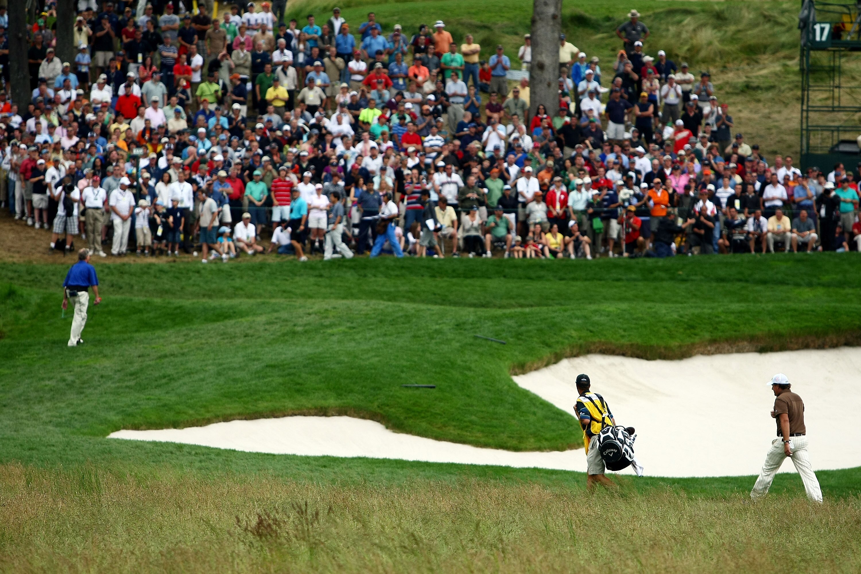 FARMINGDALE, NY - JUNE 22:  Phil Mickelson and his caddie Jim Mackay walk to the 17th green during the continuation of the final round of the 109th U.S. Open on the Black Course at Bethpage State Park on June 22, 2009 in Farmingdale, New York.  (Photo by