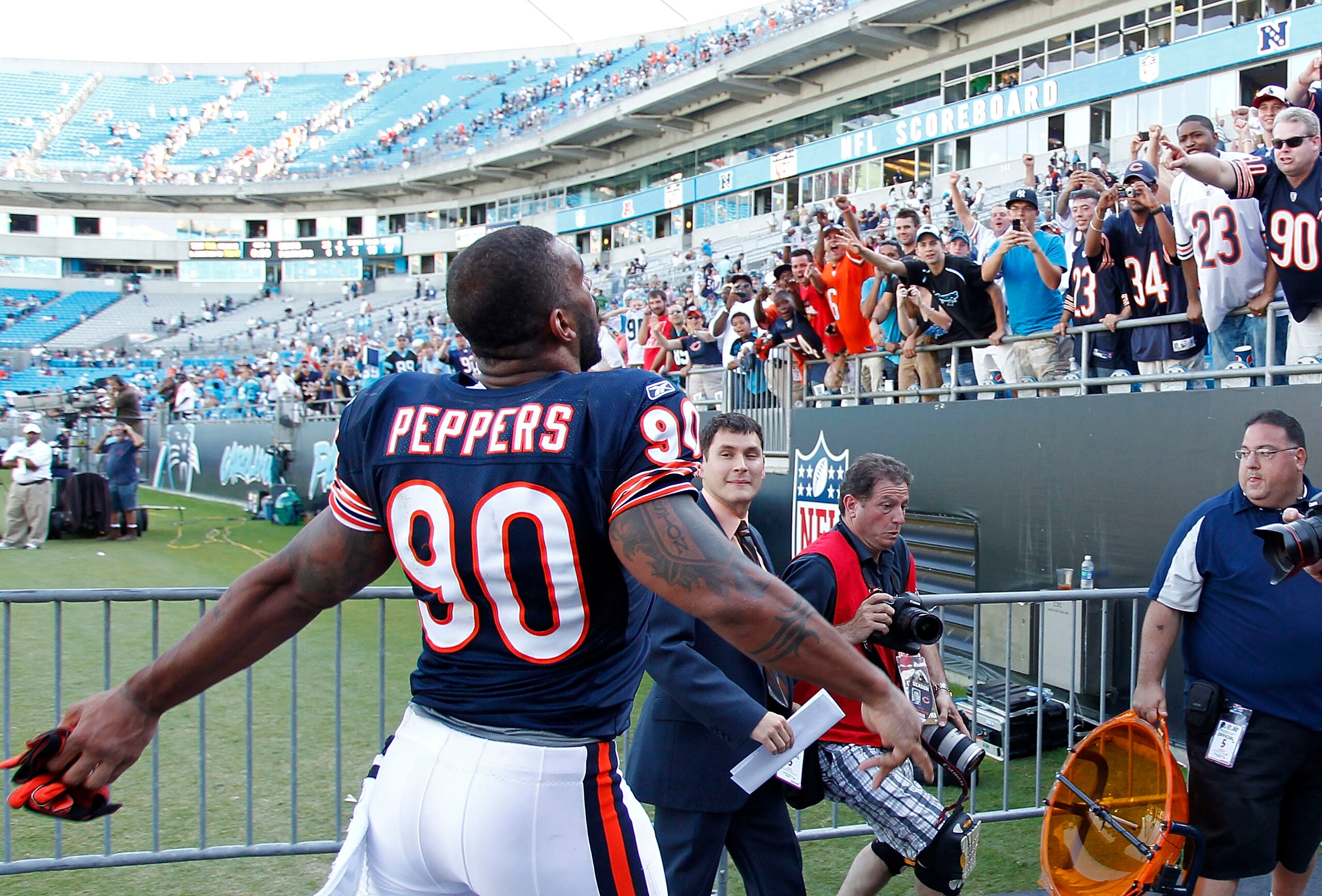 CHARLOTTE, NC - OCTOBER 10: Defensive end Julius Peppers #90 of the Chicago Bears throws his gloves into the stands as he leaves the field after the Bears game against the Carolina Panthers at Bank of America Stadium on October 10, 2010 in Charlotte, Nort