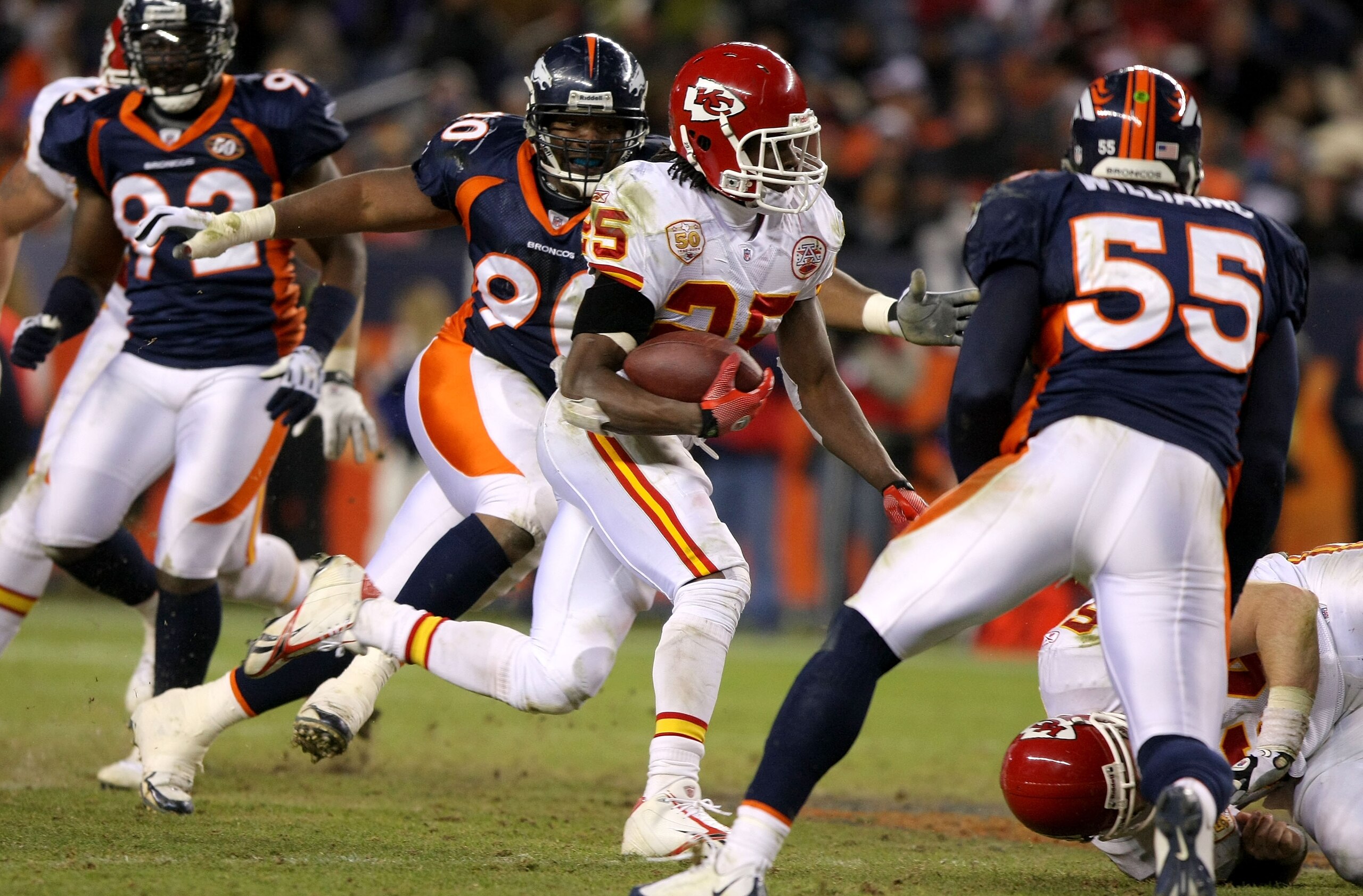 DENVER - JANUARY 03: Jamaal Charles #25 of the Kansas City Chiefs rushes through the defense of the Denver Broncos for a 56 yard fourth quarter touchdown during NFL action at Invesco Field at Mile High on January 3, 2010 in Denver, Colorado. (Photo by Dou