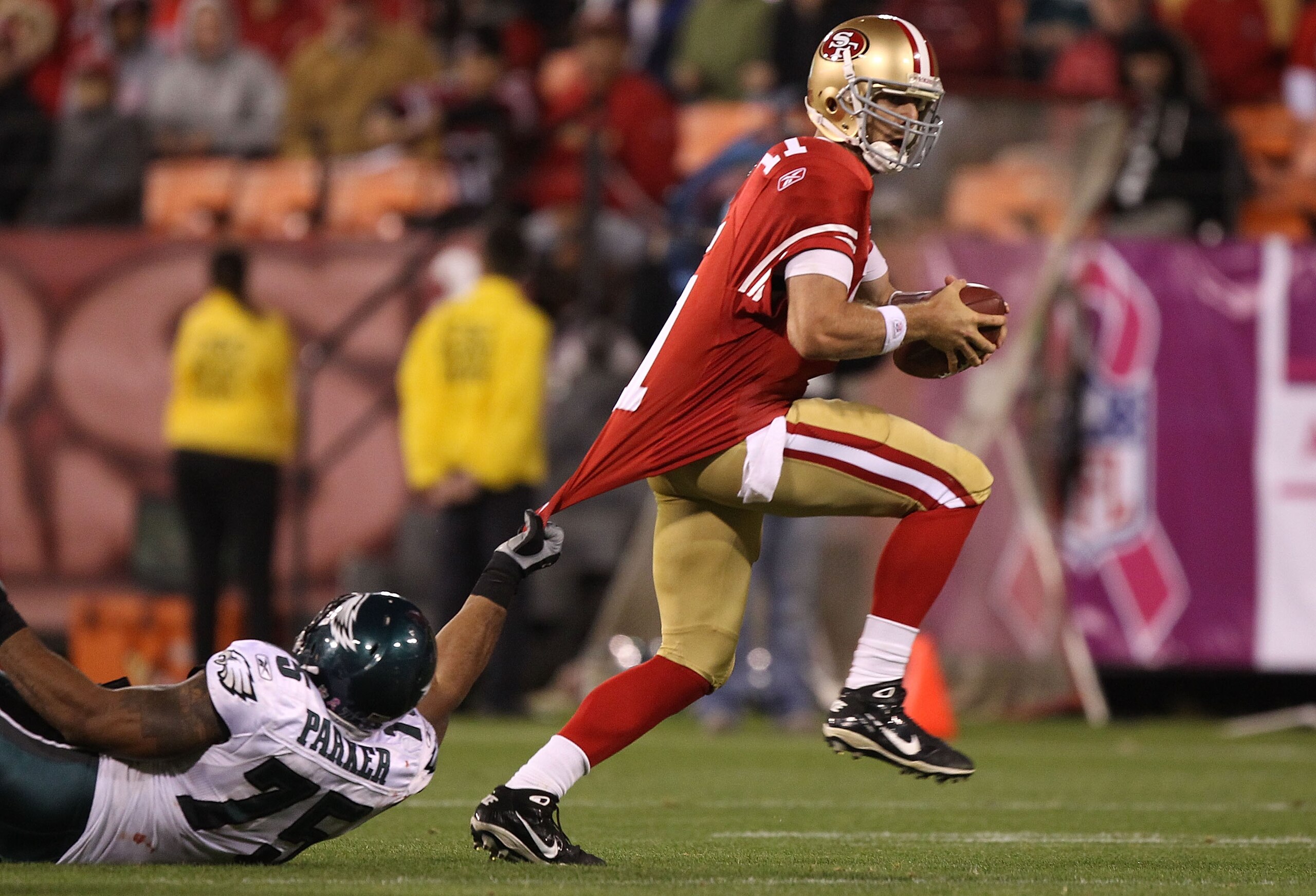 SAN FRANCISCO - OCTOBER 10:  Alex Smith #11 of the San Francisco 49ers is tackled by Juqua Parker #75 of the Philadelphia Eagles during an NFL game at Candlestick Park on October 10, 2010 in San Francisco, California.  (Photo by Jed Jacobsohn/Getty Images