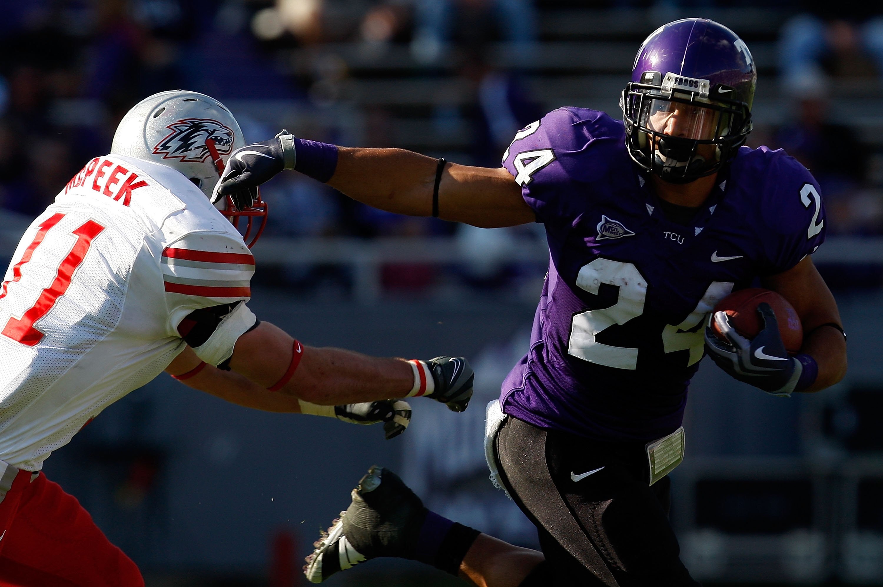 FORT WORTH, TX - NOVEMBER 28:  Tailback Joseph Turner #24 of the TCU Horned Frogs runs the ball past Clint McPeek #11 of the New Mexico Lobos at Amon G. Carter Stadium on November 28, 2009 in Fort Worth, Texas.  (Photo by Ronald Martinez/Getty Images)