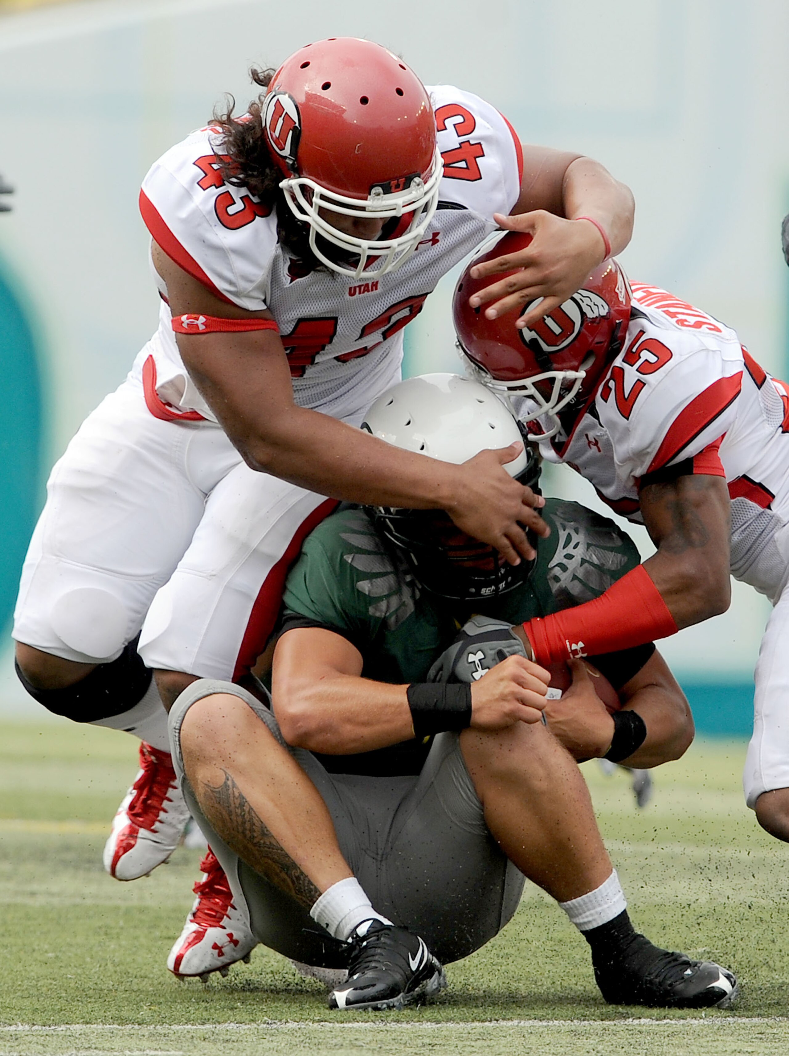 EUGENE, OR - SEPTEMBER 19: Jeremiah Masoli #8 of the Oregon Ducks is hit by Lei Talamaivao #43 and R.J. Stanford #25 of the Utah Utes in the third quarter at Autzen Stadium on September 19, 2009 in Eugene, Oregon. Oregon won the game 31-24. (Photo by Stev