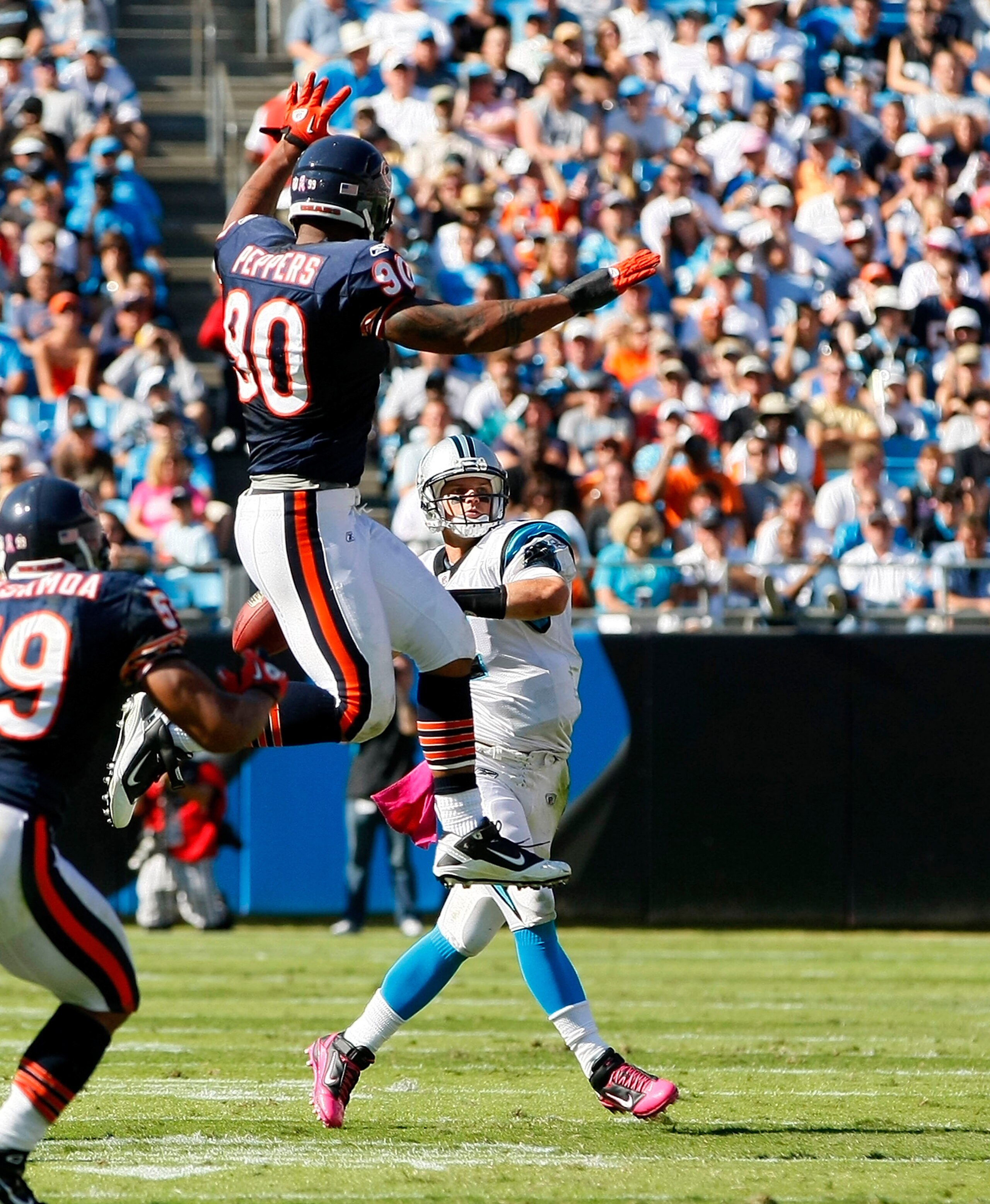 CHARLOTTE, NC - OCTOBER 10: Quarterback Jimmy Clausen #2 of the Carolina Panthers throws the ball over defensive end Julius Peppers #90 of the Chicago Bears at Bank of America Stadium on October 10, 2010 in Charlotte, North Carolina. (Photo by Geoff Burke