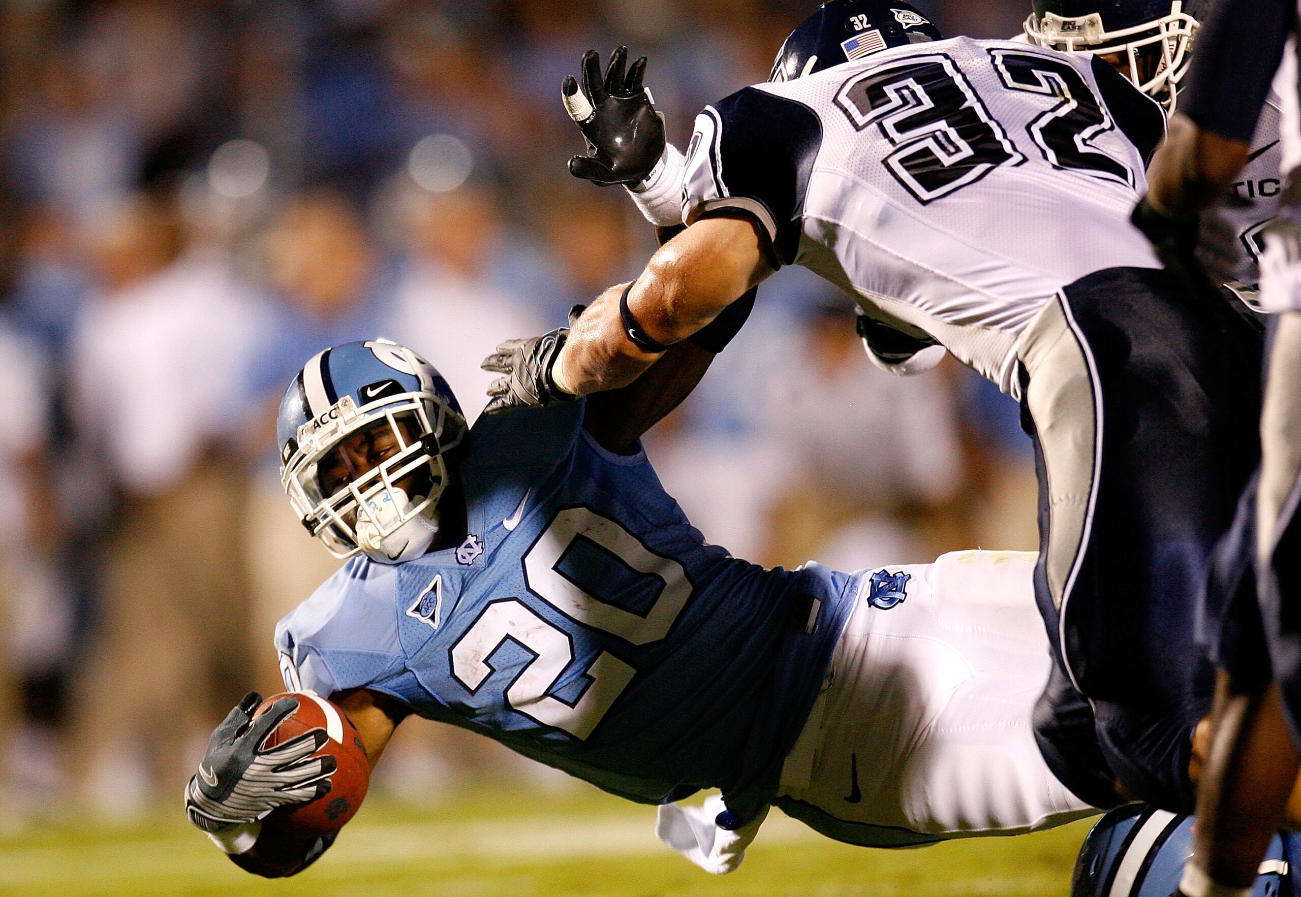 CHAPEL HILL, NC - OCTOBER 04:  Running back Shaun Draughn #20 of the North Carolina Tar Heels dives for more yardage against Scott Lutrus #32 of the Connecticut Huskies during the game at Kenan Stadium on October 4, 2008 in Chapel Hill, North Carolina.  (