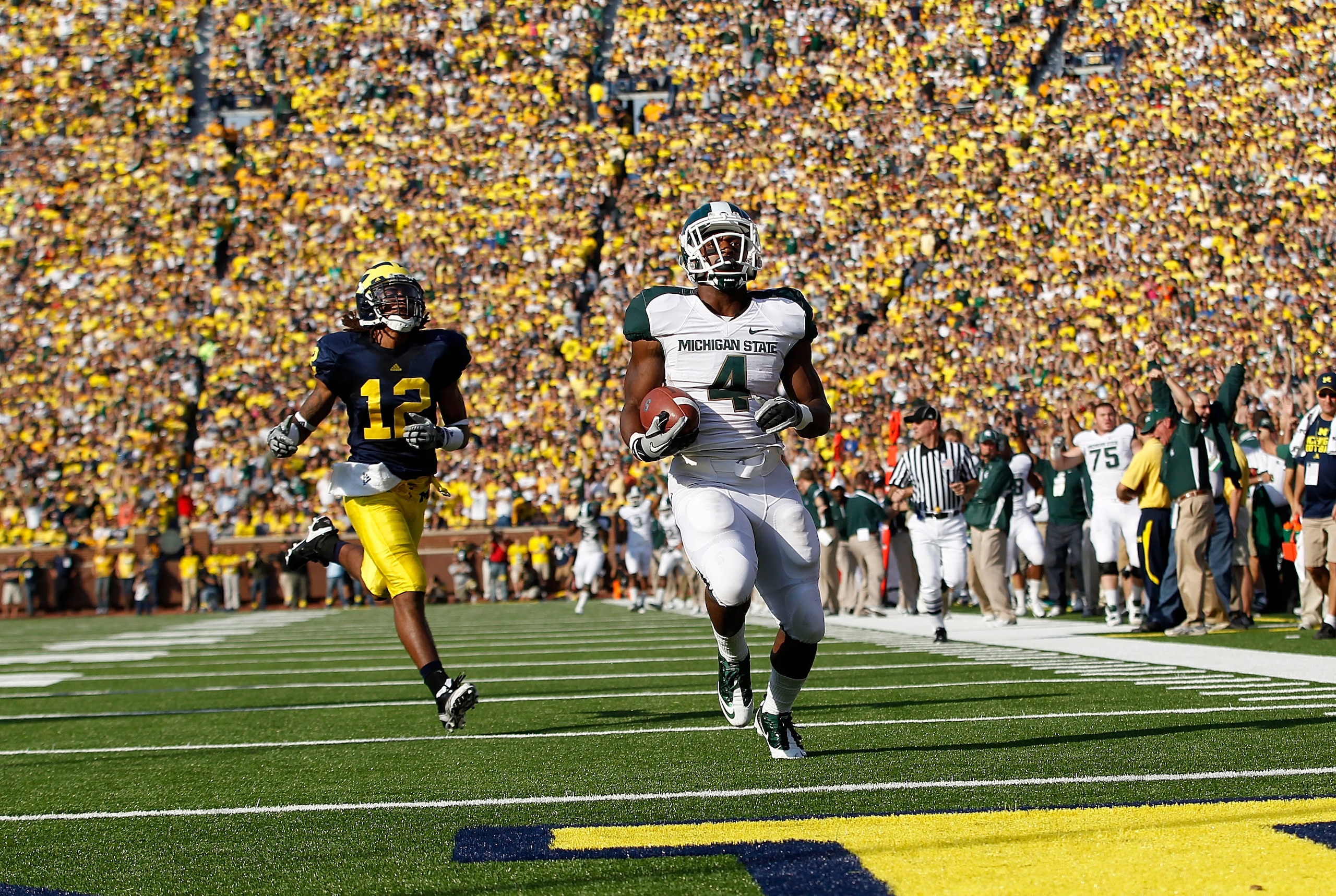 ANN ARBOR, MI - OCTOBER 09: Edwin Baker #4 of the Michigan State Spartans scores on a 61 yard touchdown in the second quarter against the Michigan Wolverines during the game on October 9, 2010 at Michigan Stadium in Ann Arbor, Michigan. The Michigan Stat ANN ARBOR, MI - OCTOBER 09: Edwin Baker #4 of the Michigan State Spartans scores on a 61 yard touchdown in the second quarter against the Michigan Wolverines during the game on October 9, 2010 at Michigan Stadium in Ann Arbor, Michigan. The Michigan Stat