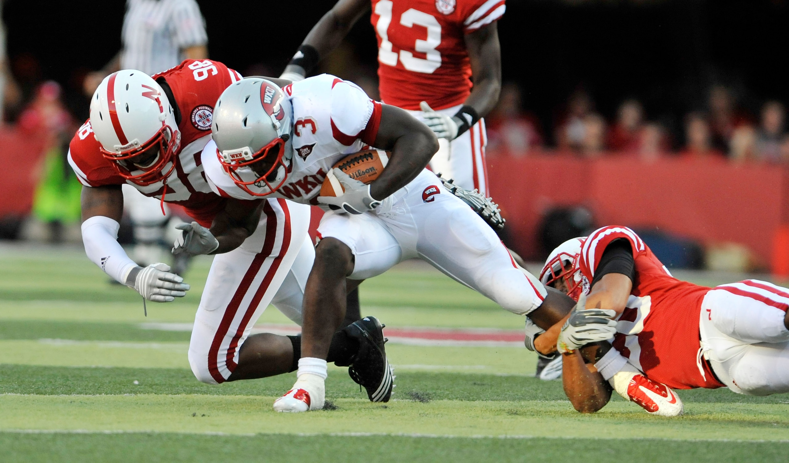LINCOLN, NE - SEPTEMBER 04: Bobby Rainey #3 of the Western Kentucky Hilltoppers gets brought down by Josh Williams #98 and Eric Hagg #28 of the Nebraska Cornhuskers during first half action of their game at Memorial Stadium on September 4, 2010 in Lincol LINCOLN, NE - SEPTEMBER 04: Bobby Rainey #3 of the Western Kentucky Hilltoppers gets brought down by Josh Williams #98 and Eric Hagg #28 of the Nebraska Cornhuskers during first half action of their game at Memorial Stadium on September 4, 2010 in Lincol