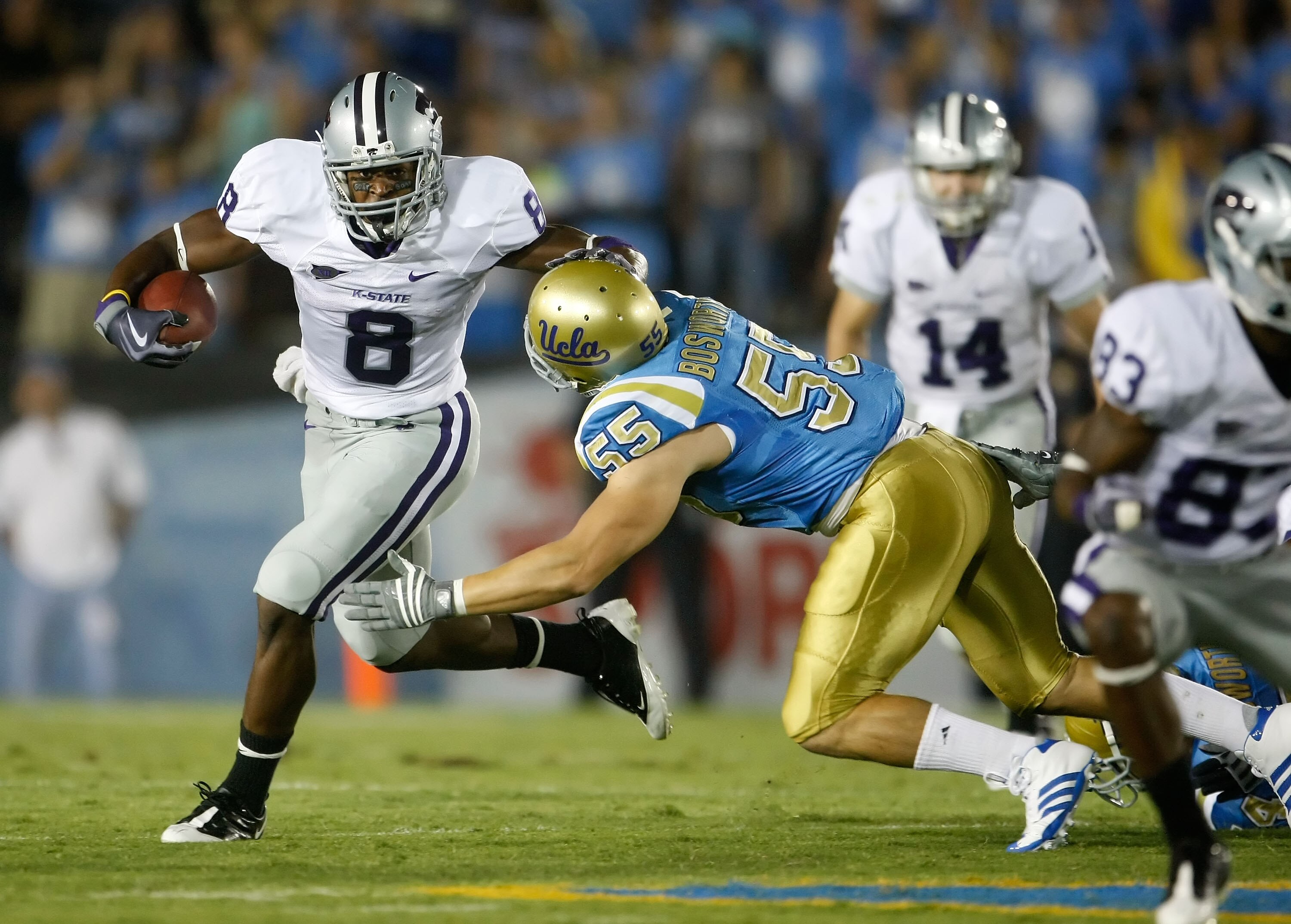 PASADENA, CA - SEPTEMBER 19:  Daniel Thomas #8 of the Kansas State Wildcats is pursued by Korey Bosworth #55 of the UCLA Bruins in the first quarter at the Rose Bowl on September 19, 2009 in Pasadena, California. UCLA defeated Kansas State 23-9.  (Photo b