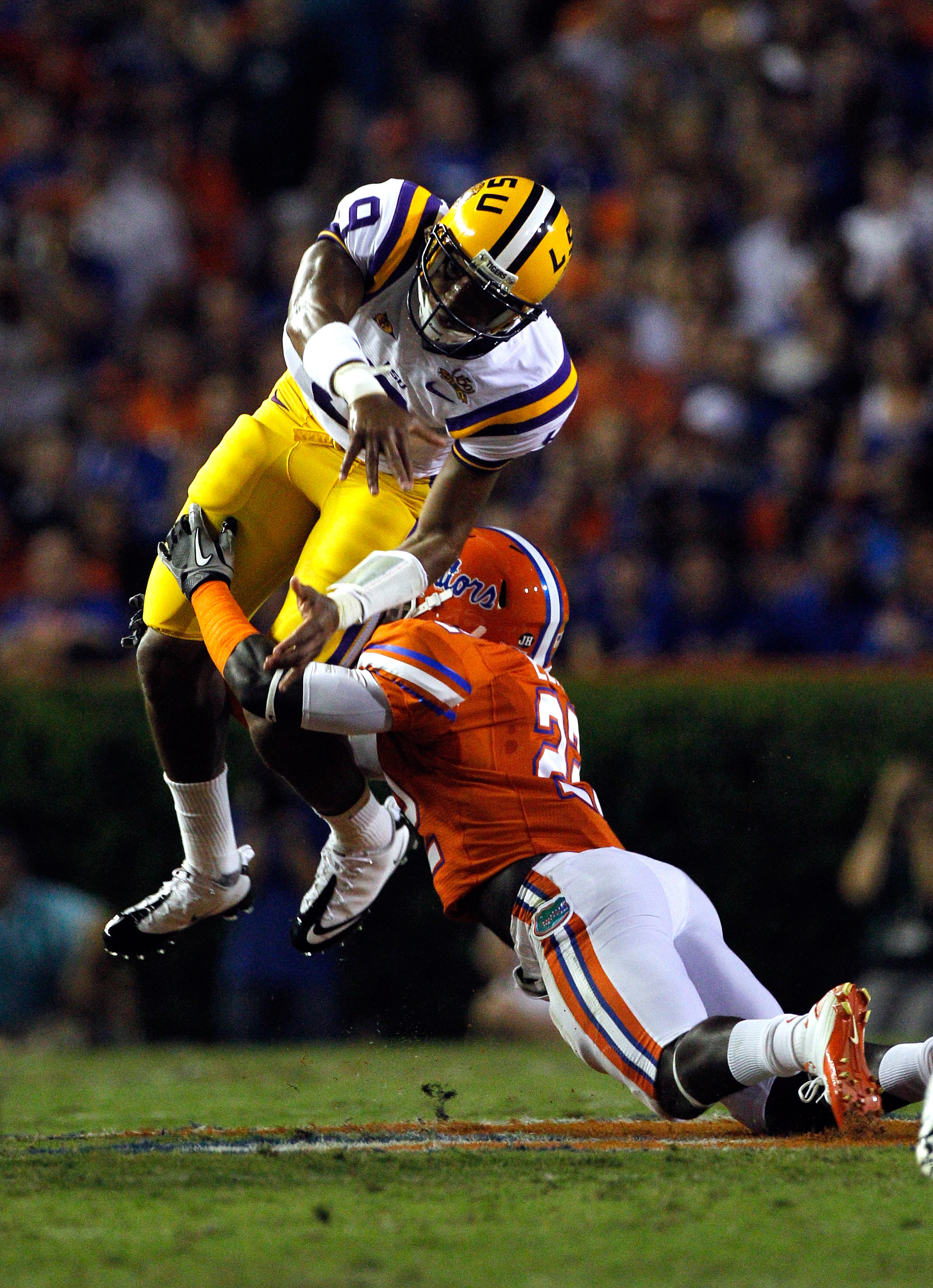 GAINESVILLE, FL - OCTOBER 09:  Quarterback Jordan Jefferson #9 of the Louisiana State University Tigers is tackled by Matt Elam #22 of the Florida Gators during the game at Ben Hill Griffin Stadium on October 9, 2010 in Gainesville, Florida.  (Photo by Sa