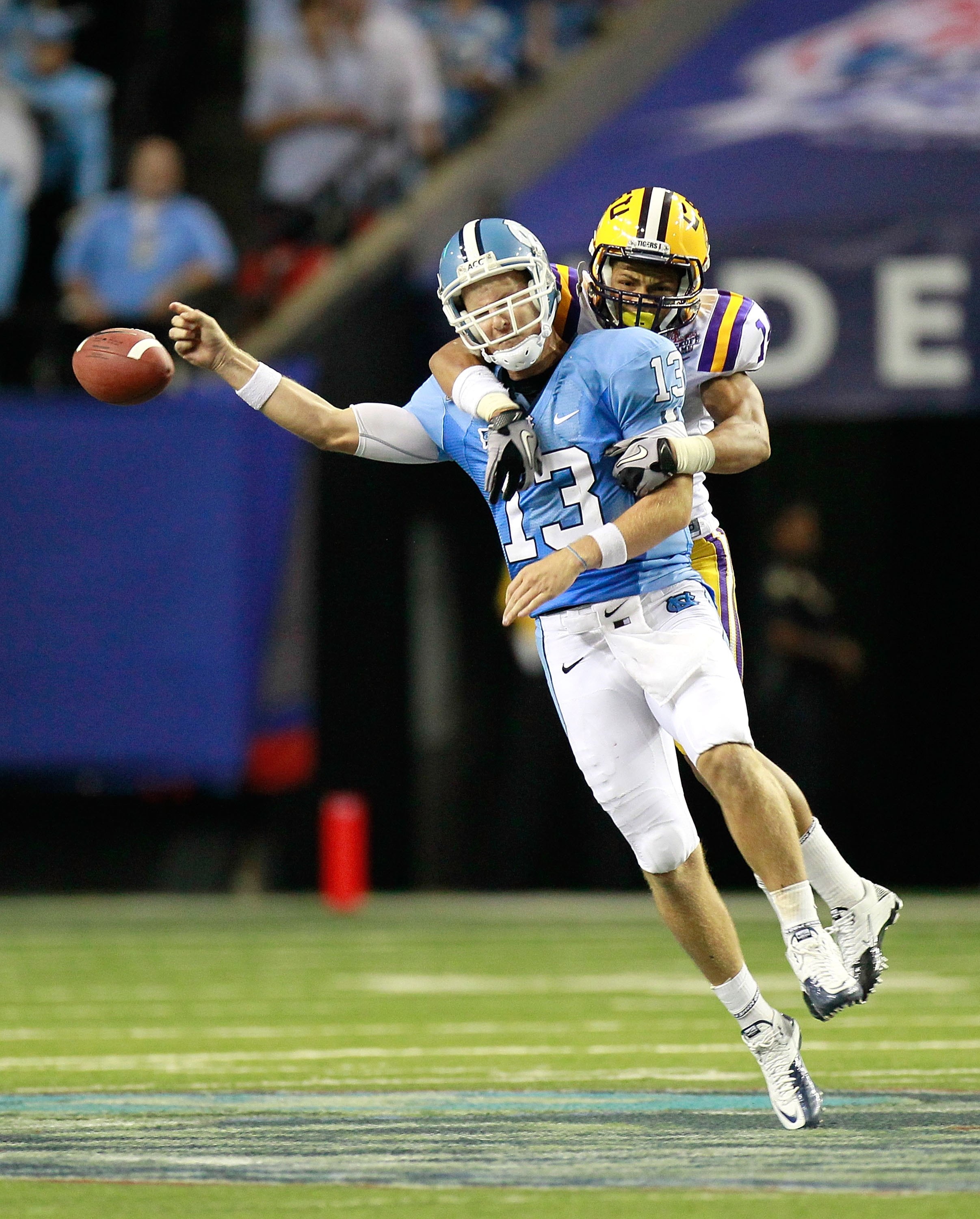 ATLANTA - SEPTEMBER 04:  Tyrann Mathieu #14 of the LSU Tigers forces a fumble by quarterback T.J. Yates #13 of the North Carolina Tar Heels during the Chick-fil-A Kickoff Game at Georgia Dome on September 4, 2010 in Atlanta, Georgia.  (Photo by Kevin C. C