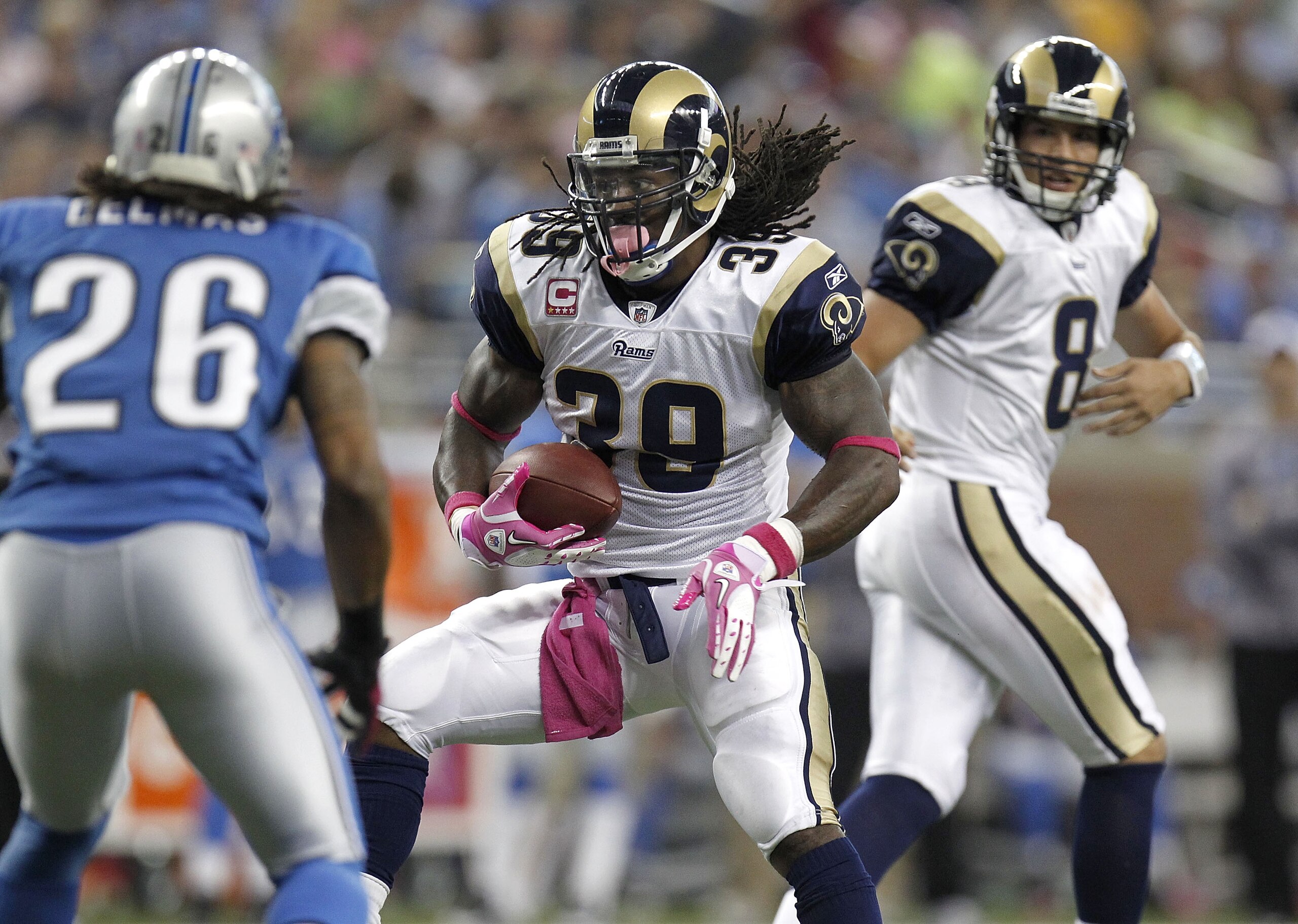 DETROIT - OCTOBER 10:  Steven Jackson #39 of the St. Louis Rams takes a handoff from Sam Bradford and tries to get around the tackle of Louis Delmas #26 of the Detroit Lions on October 10, 2010 at Ford Field in Detroit, Michigan.  (Photo by Gregory Shamus