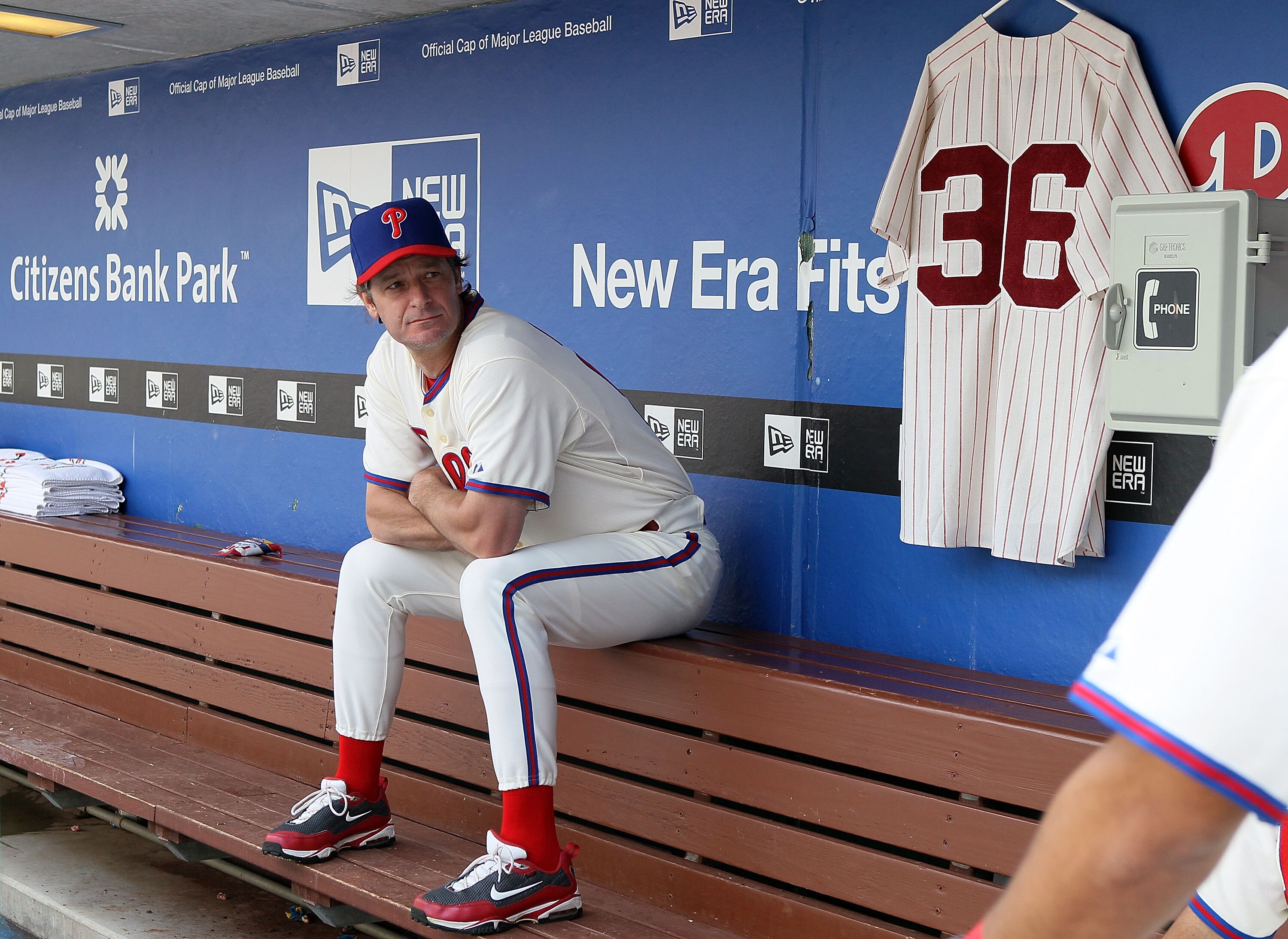PHILADELPHIA - MAY 06:  Jamie Moyer #50 of the Philadelphia Phillies sits in the dugout next to a jersey of Phillies Hall of Fame pitcher Robin Roberts prior to playing the St. Louis Cardinals at Citizens Bank Park on May 6, 2010 in Philadelphia, Pennsylv