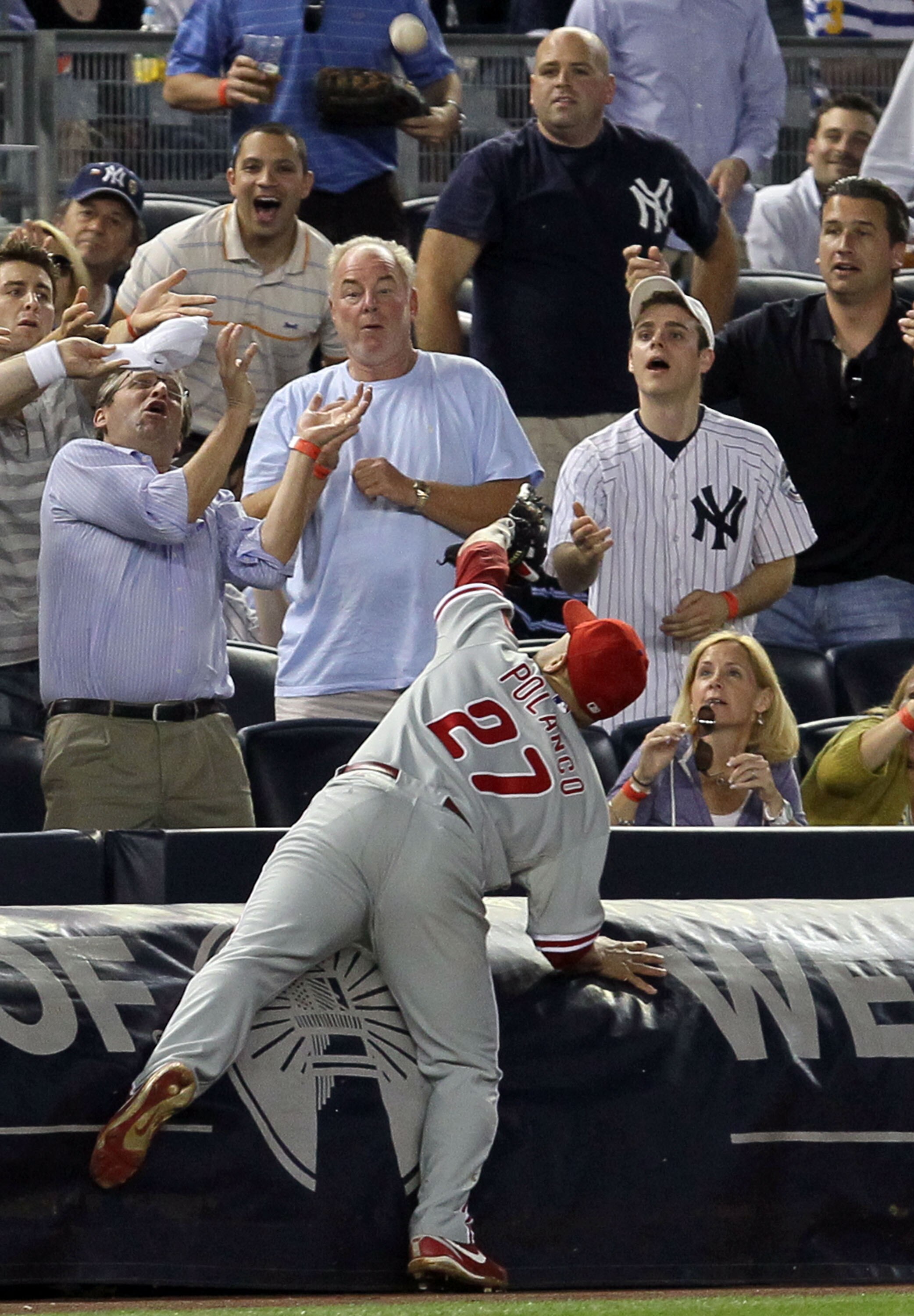 NEW YORK - JUNE 17:  Placido Polanco #27 of the Philadelphia Phillies makes a catch against Nick Swisher (not pictured) of the New York Yankees for the final out of the sixth inning on June 17, 2010 at Yankee Stadium in the Bronx borough of New York City.