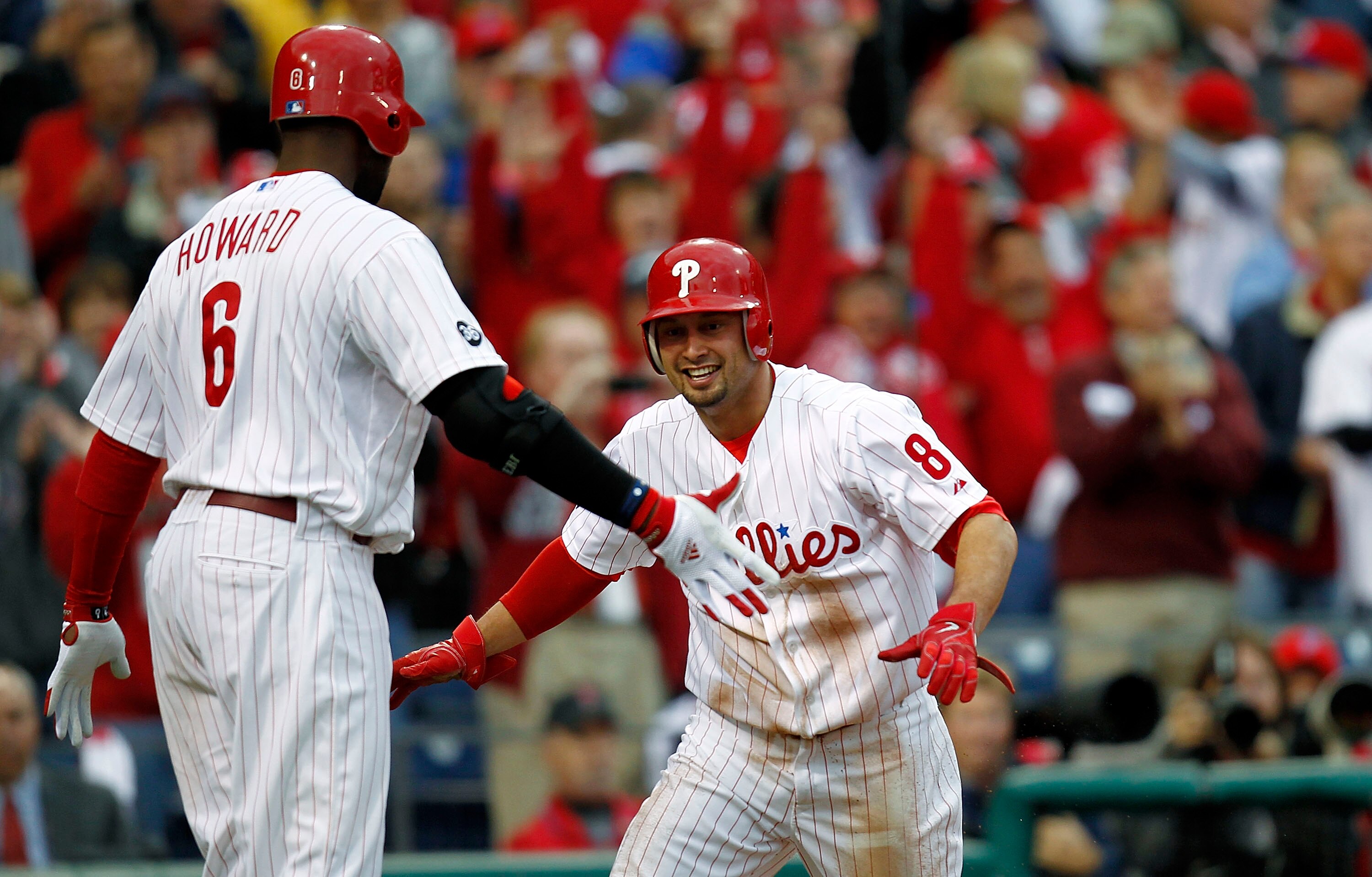 PHILADELPHIA - OCTOBER 06: Ryan Howard #6 and Shane Victorino #8 of the Philadelphia Phillies celebrate a run in Game 1 of the NLDS against the Cincinnati Reds at Citizens Bank Park on October 6, 2010 in Philadelphia, Pennsylvania.  (Photo by Jeff Zelevan