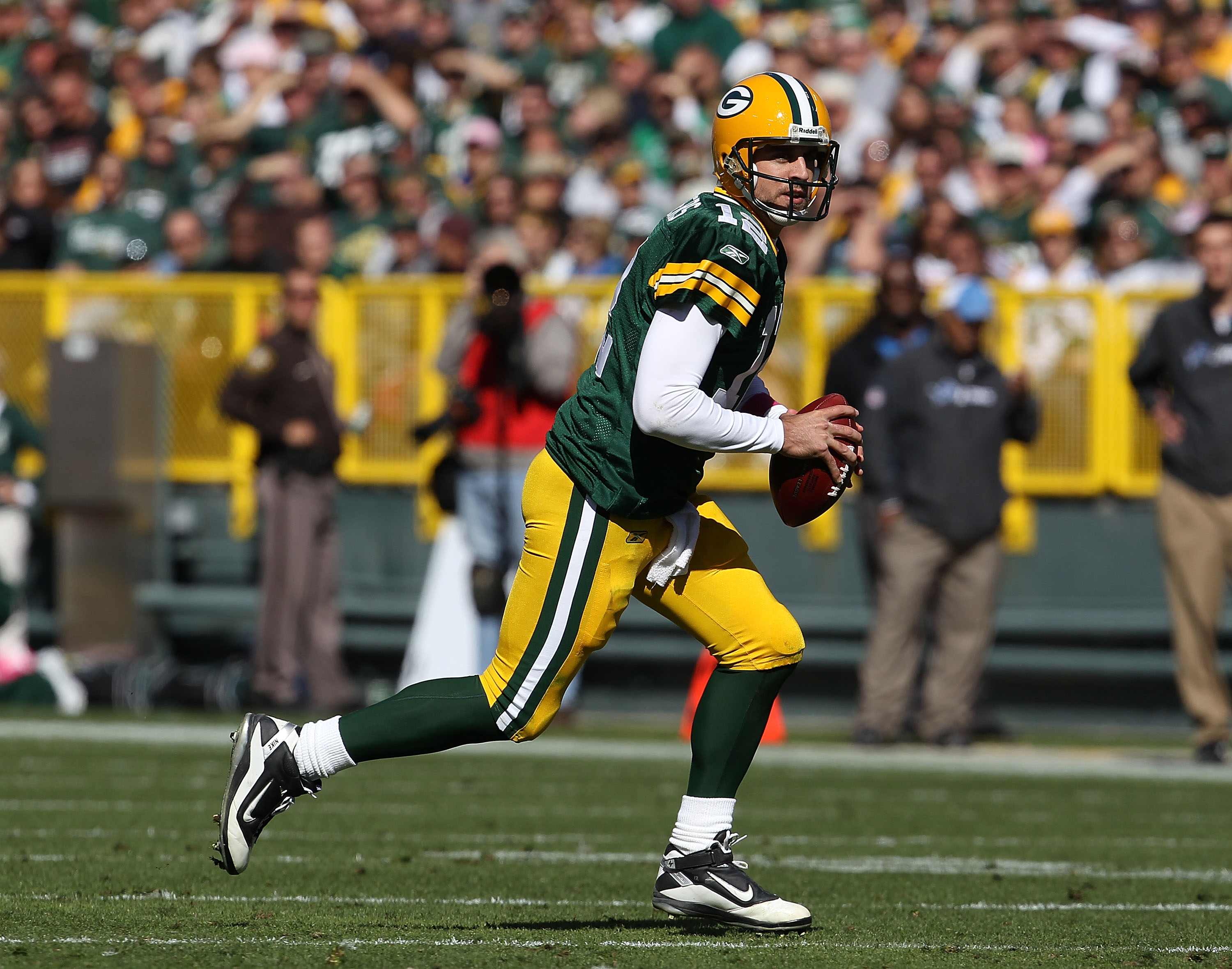 GREEN BAY, WI - OCTOBER 03: Aaron Rodgers #12 of the Green Bay Packers rolls out to look for a receiver against the Detroit Lions at Lambeau Field on October 3, 2010 in Green Bay, Wisconsin. The Packers defeated the Lions 28-26. (Photo by Jonathan Daniel/