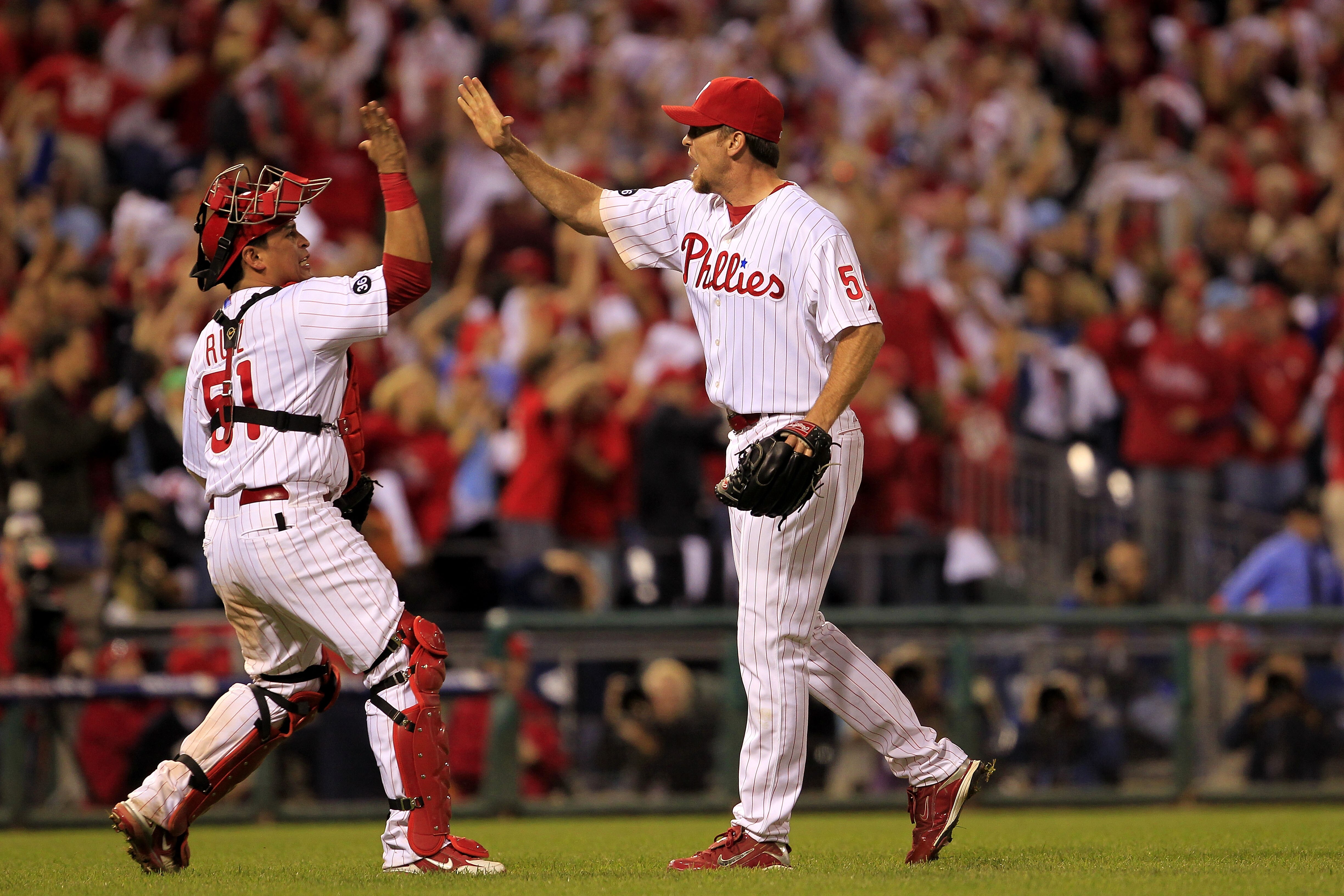 PHILADELPHIA - OCTOBER 08:  Carlos Ruiz #51 and Brad Lidge #54 of the Philadelphia Phillies celebrate a victory over the Cincinnati Reds in game 2 of NLDS at Citizens Bank Park on October 8, 2010 in Philadelphia, Pennsylvania. The Phillies defeated the Re