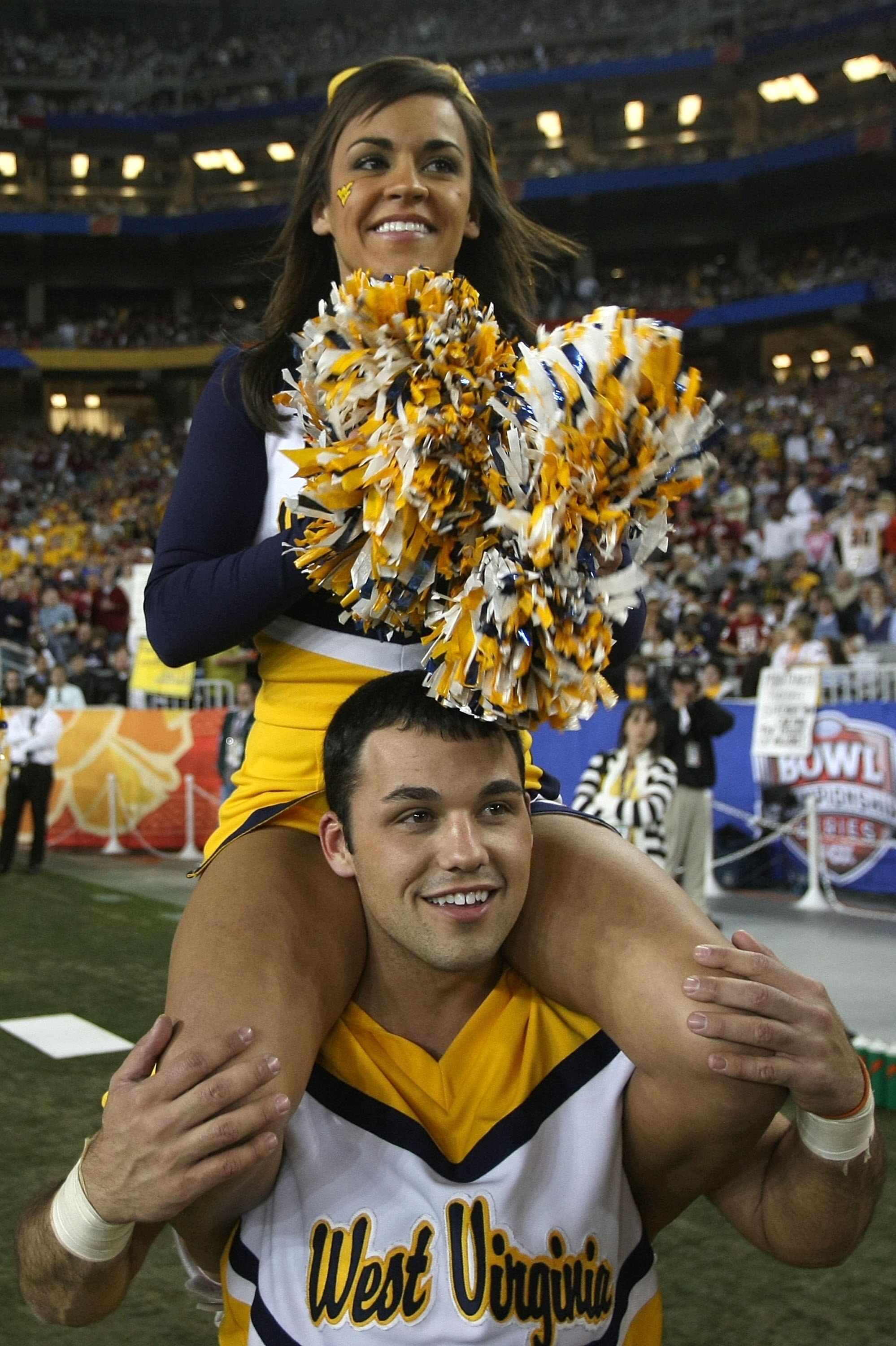 GLENDALE, AZ - JANUARY 02:  Two West Virginia Mountaineers cheerleaders roam the sideline while the Mountaineers take on the Oklahoma Sooners at the Tostito's Fiesta Bowl at University of Phoenix Stadium January 2, 2008 in Glendale, Arizona.  (Photo by St