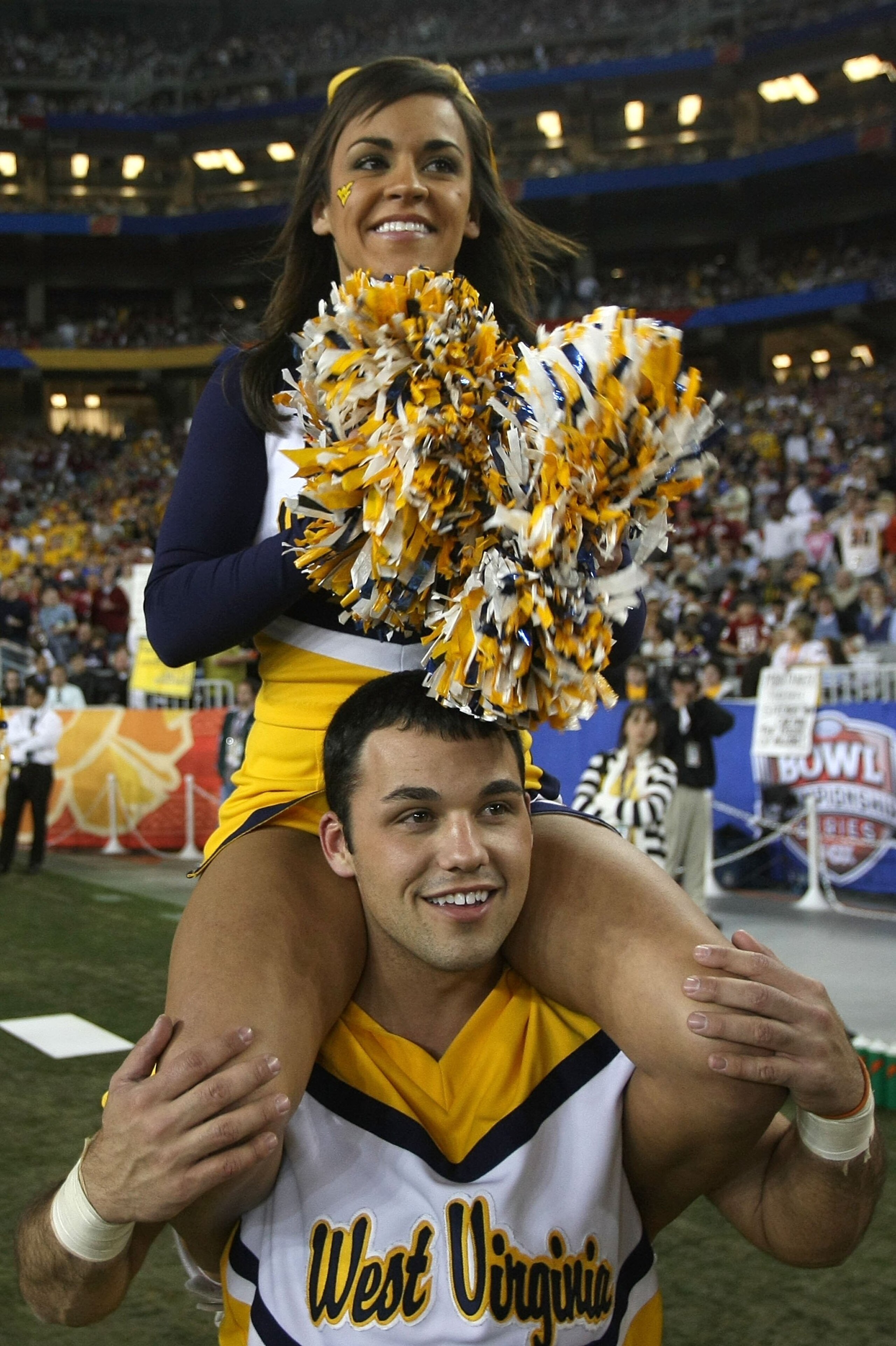 GLENDALE, AZ - JANUARY 02:  Two West Virginia Mountaineers cheerleaders roam the sideline while the Mountaineers take on the Oklahoma Sooners at the Tostito's Fiesta Bowl at University of Phoenix Stadium January 2, 2008 in Glendale, Arizona.  (Photo by St