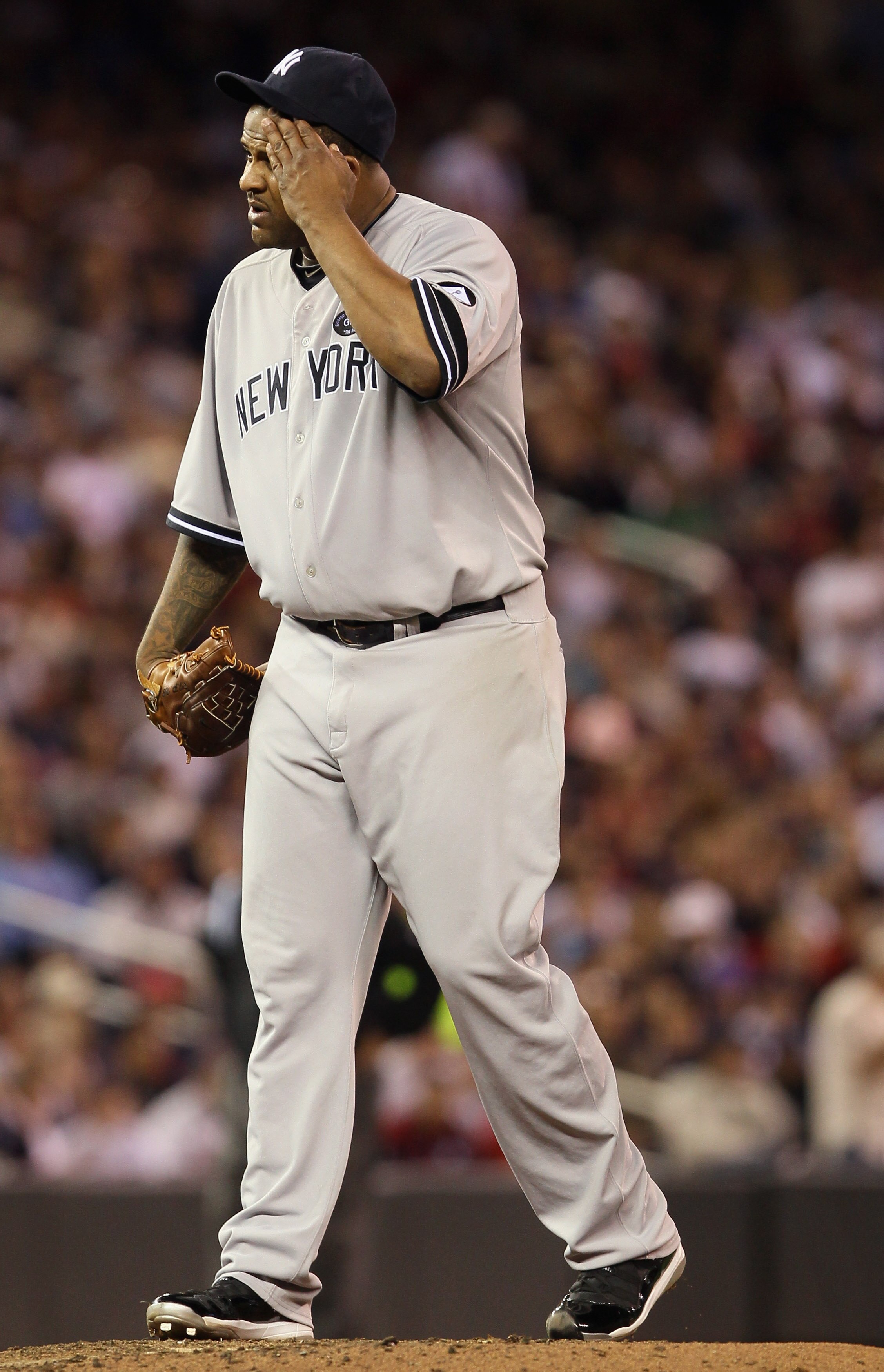 MINNEAPOLIS - OCTOBER 06:  CC Sabathia #52 of the New York Yankees wipes his face in the sixth inning against the Minnesota Twins during game one of the ALDS on October 6, 2010 at Target Field in Minneapolis, Minnesota.  (Photo by Elsa/Getty Images)